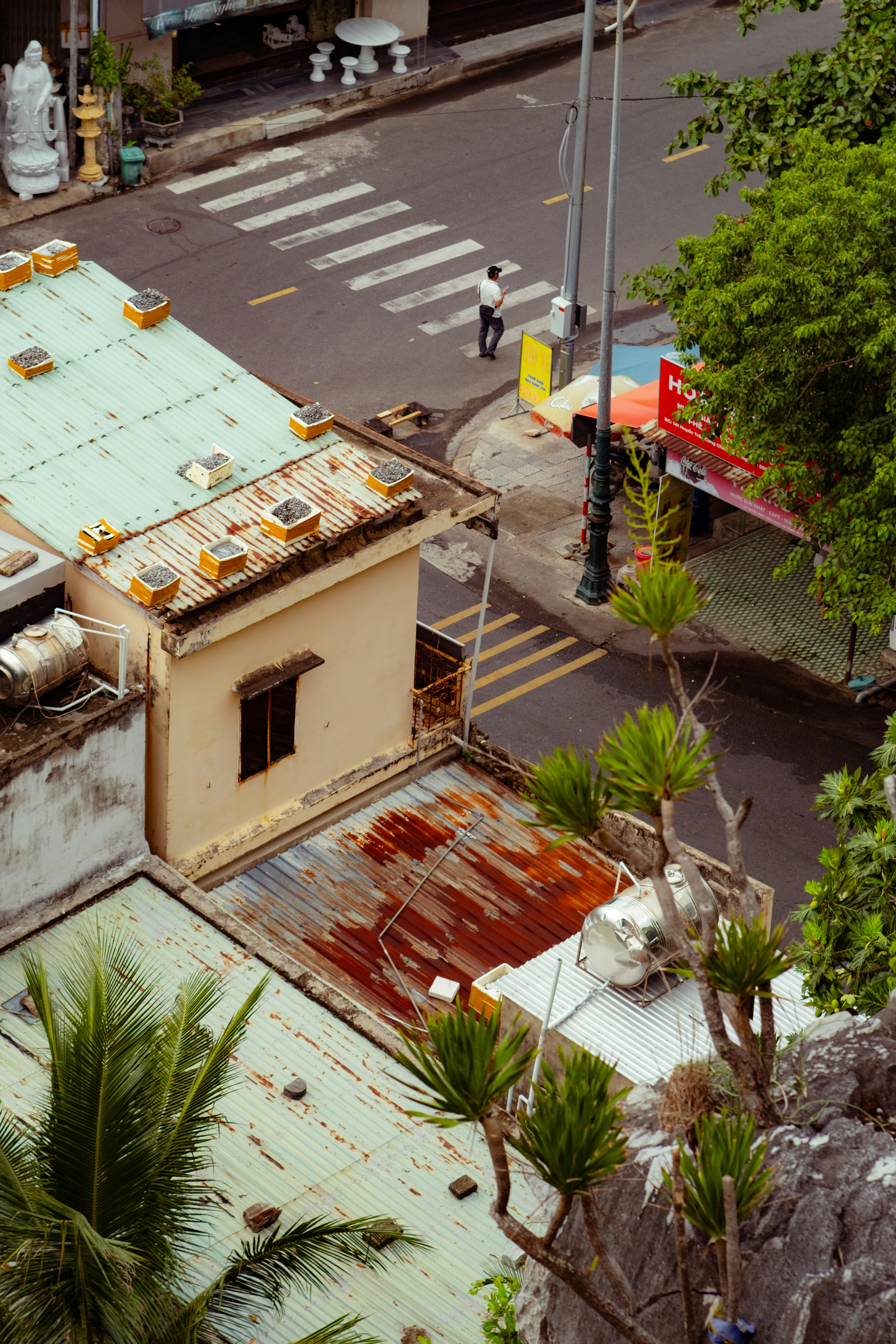 Overhead view of buildings, a street, and a pedestrian