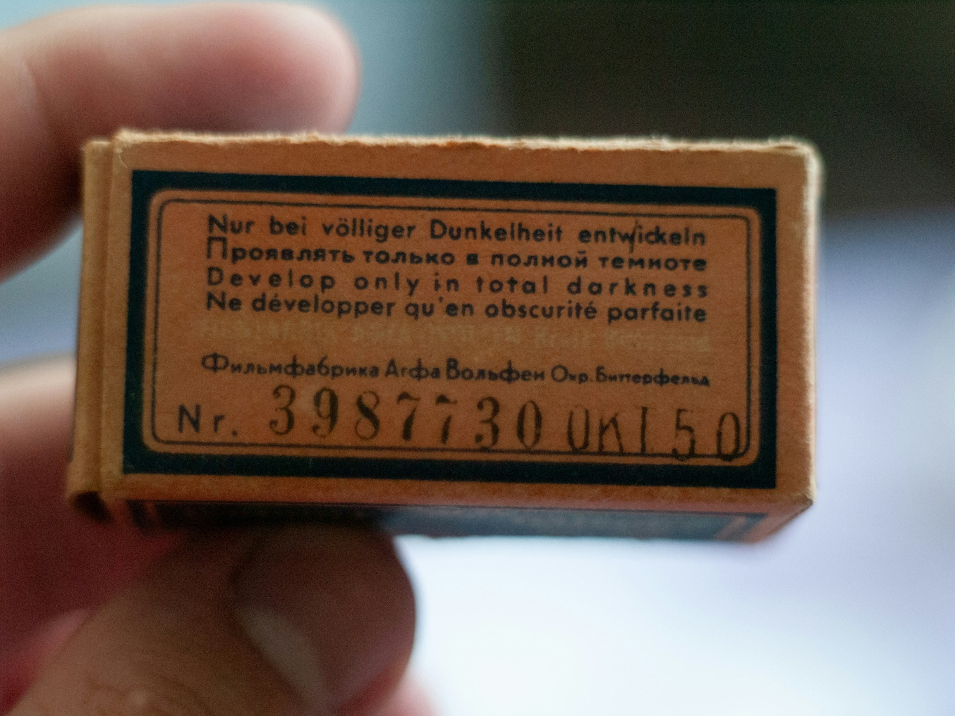 Old cardboard box with 'develop only in total darkness' text