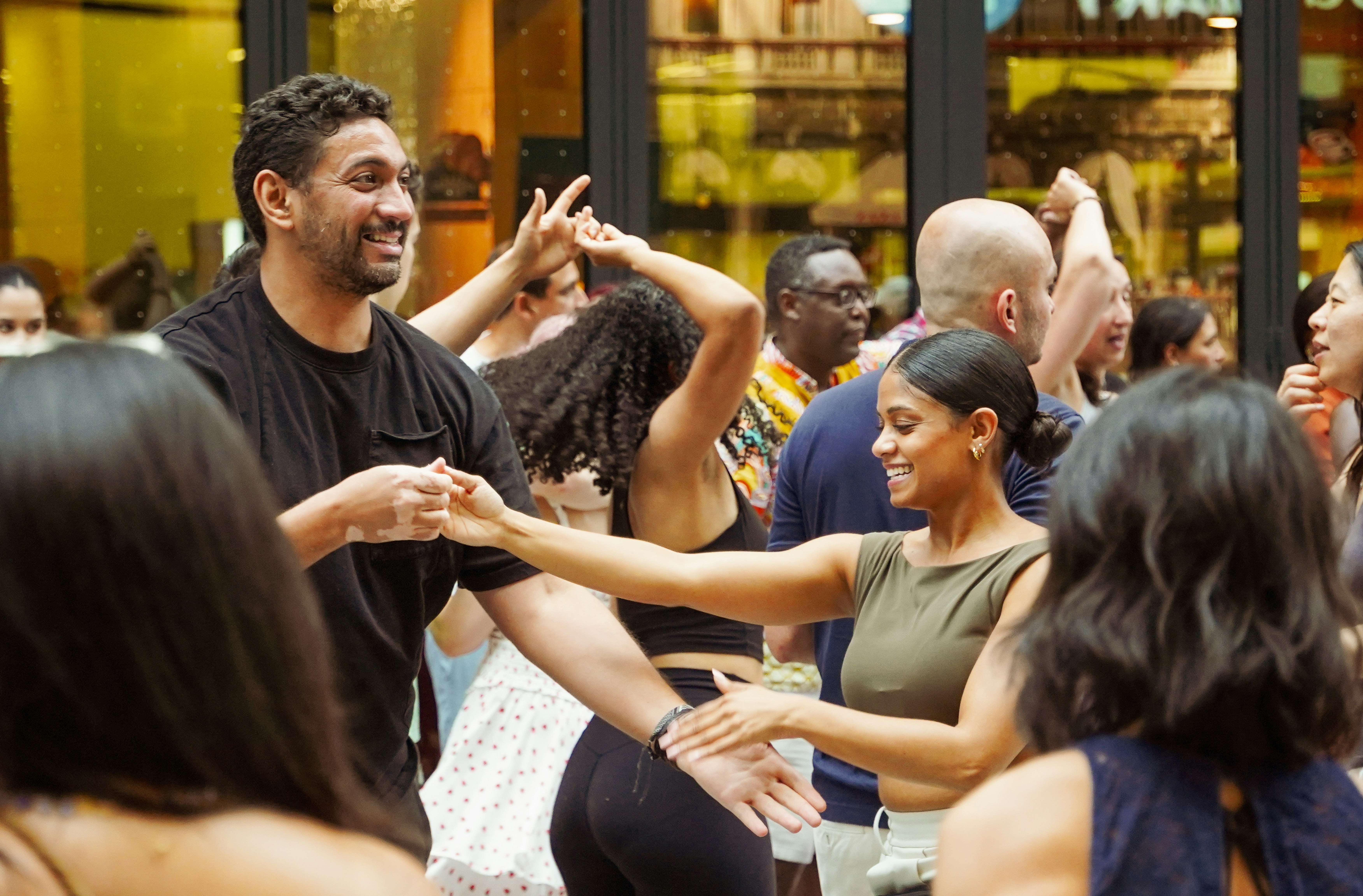 A group of diverse people smiling and dancing together