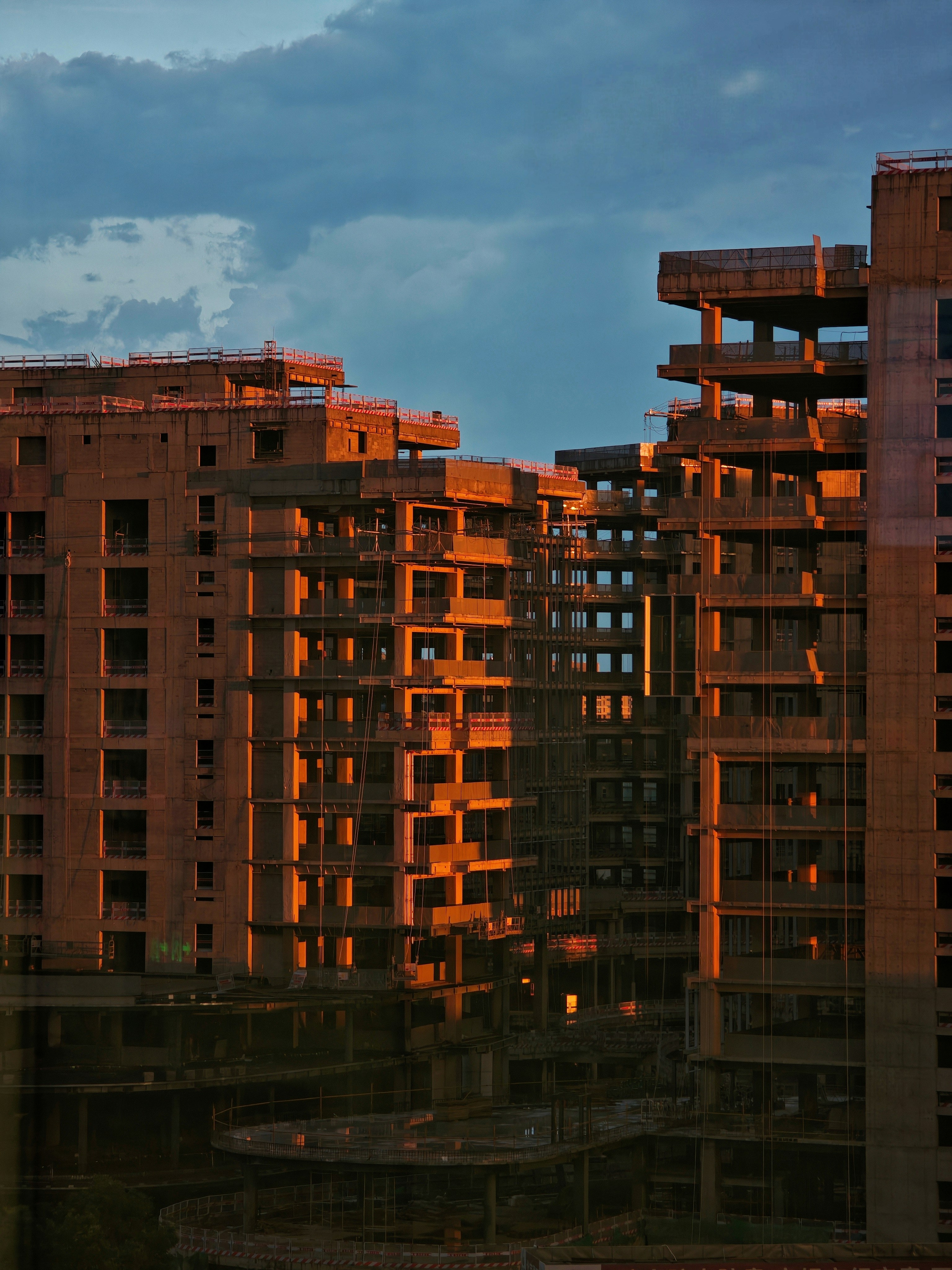 Unfinished concrete buildings in warm evening light