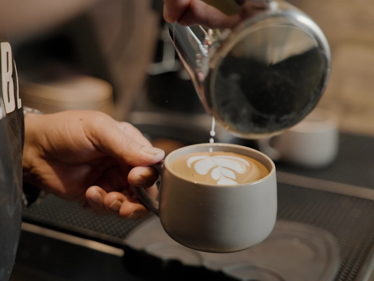 A barista pouring latte art