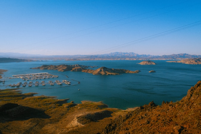 A large desert reservoir with rocky shoreline and distant mountains, similar to Lake Mead, the source of most Southern Nevada water
