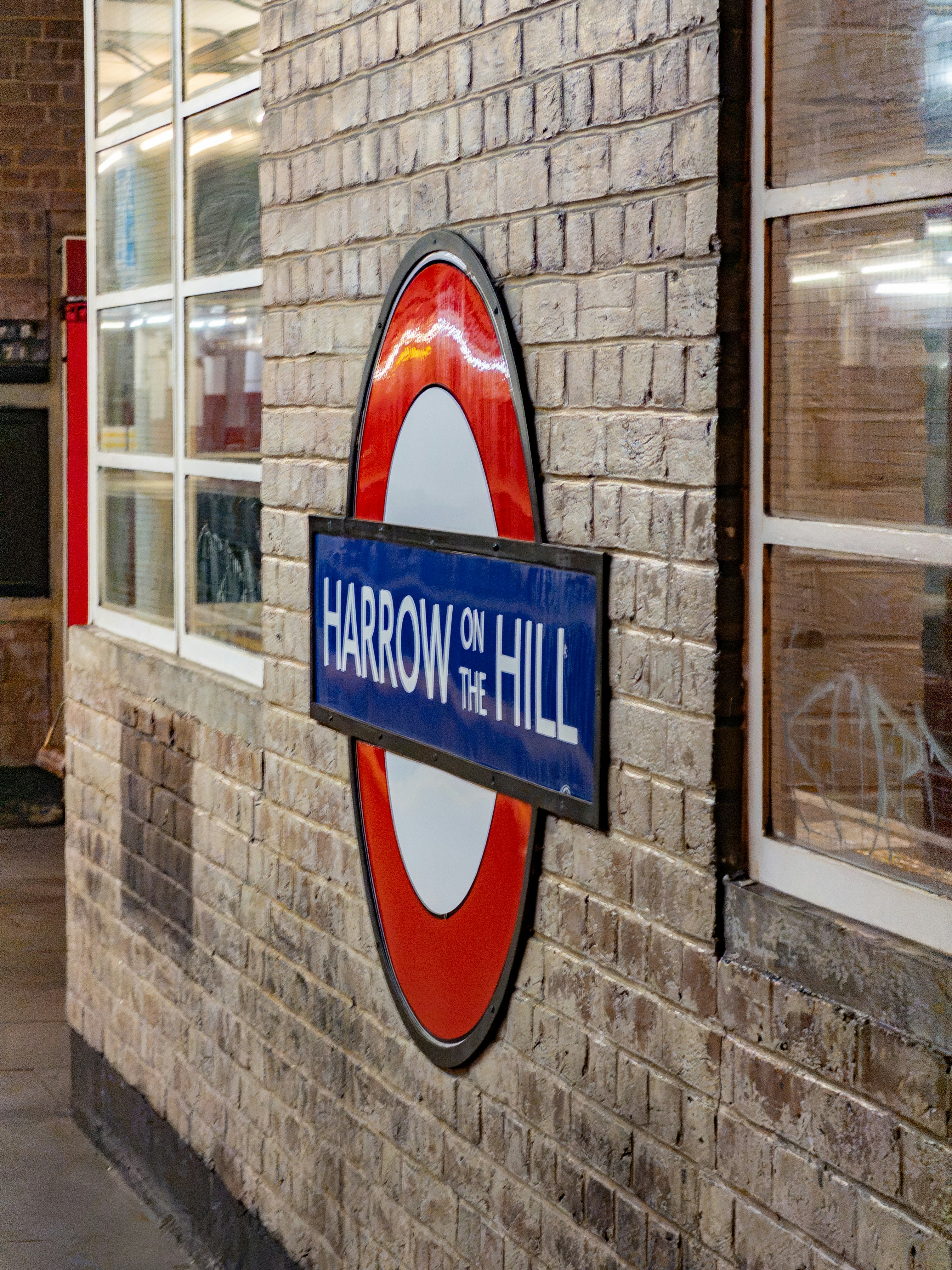 Harrow on the Hill sign on a brick wall