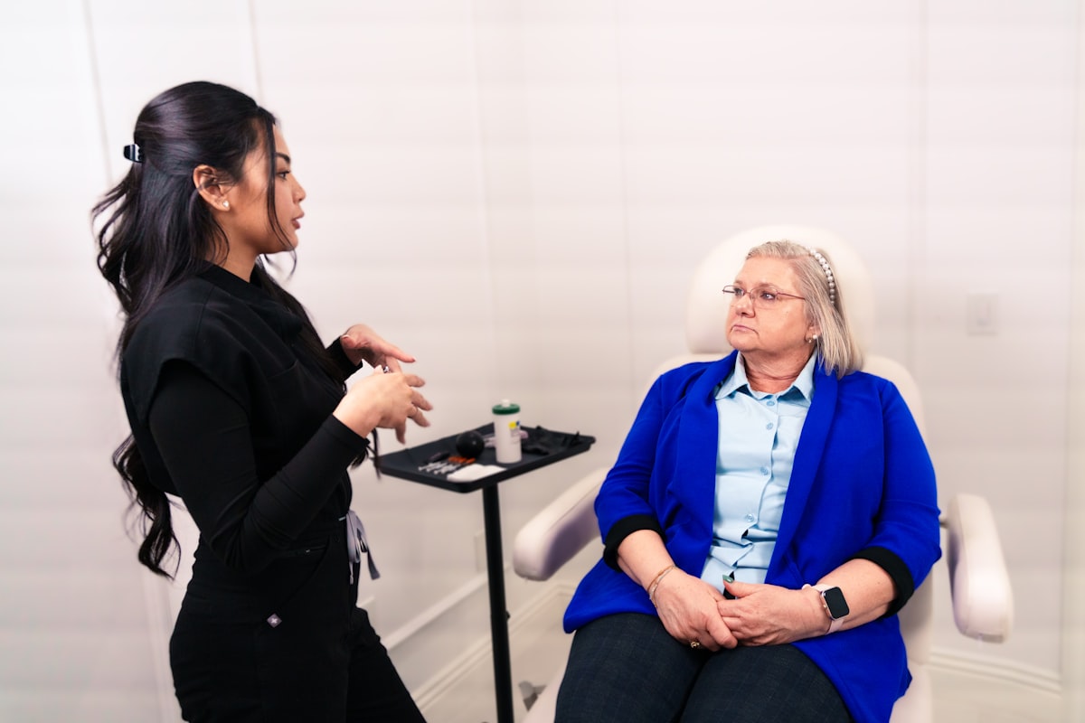 A clinician consulting with a seated patient in a medical office
