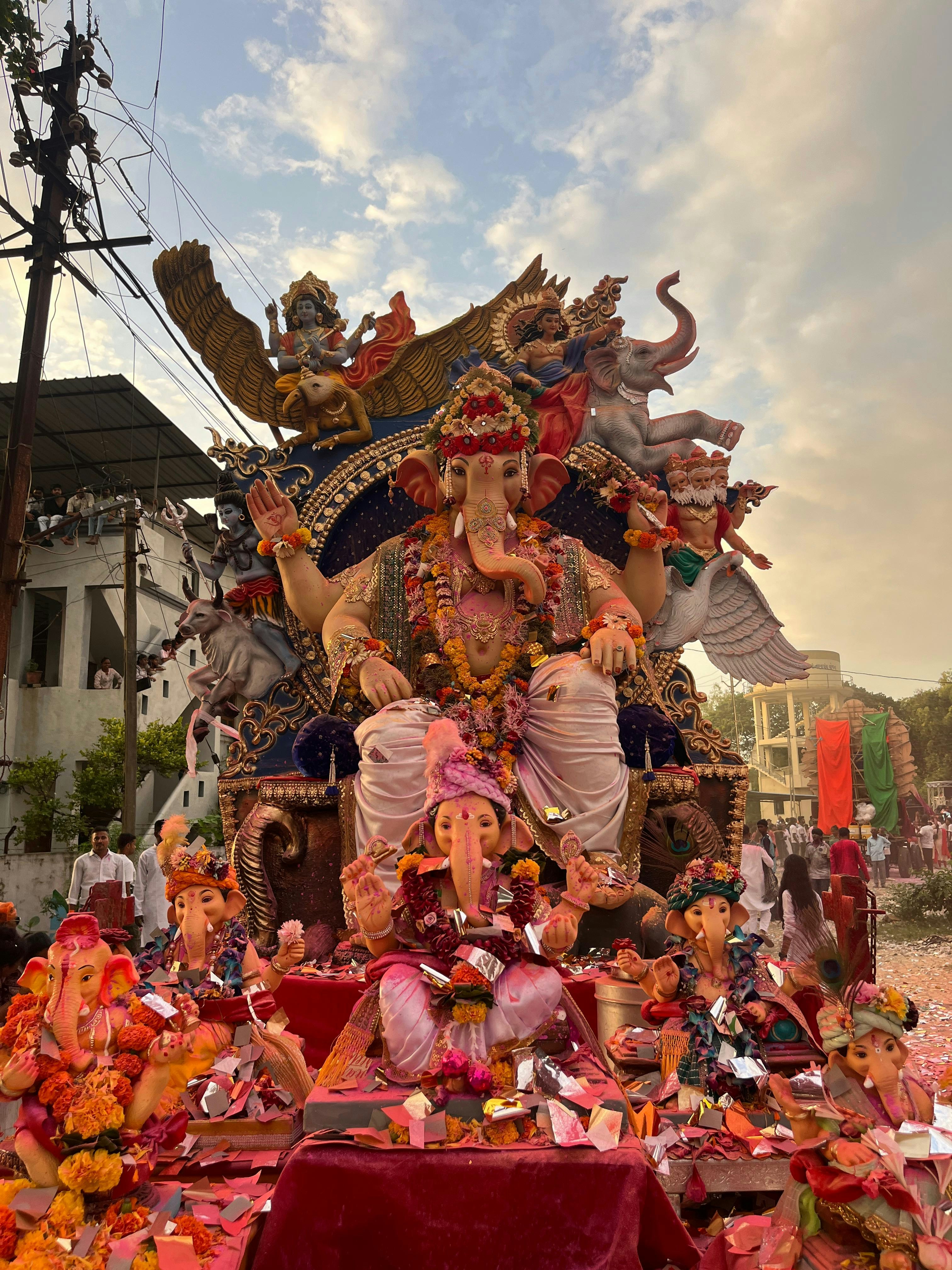 Ornate ganesha statue on a parade float with smaller idols