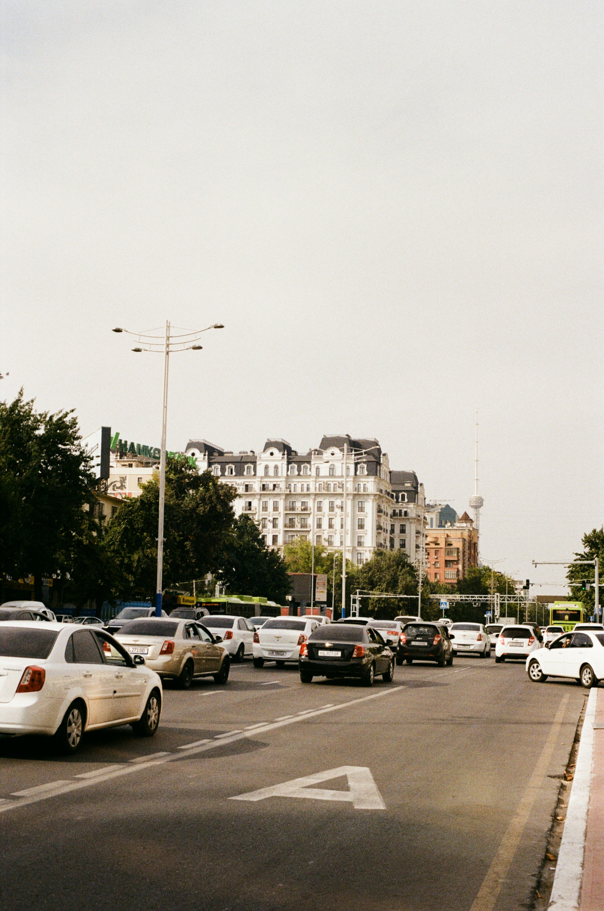 Busy city street with cars and a classic building