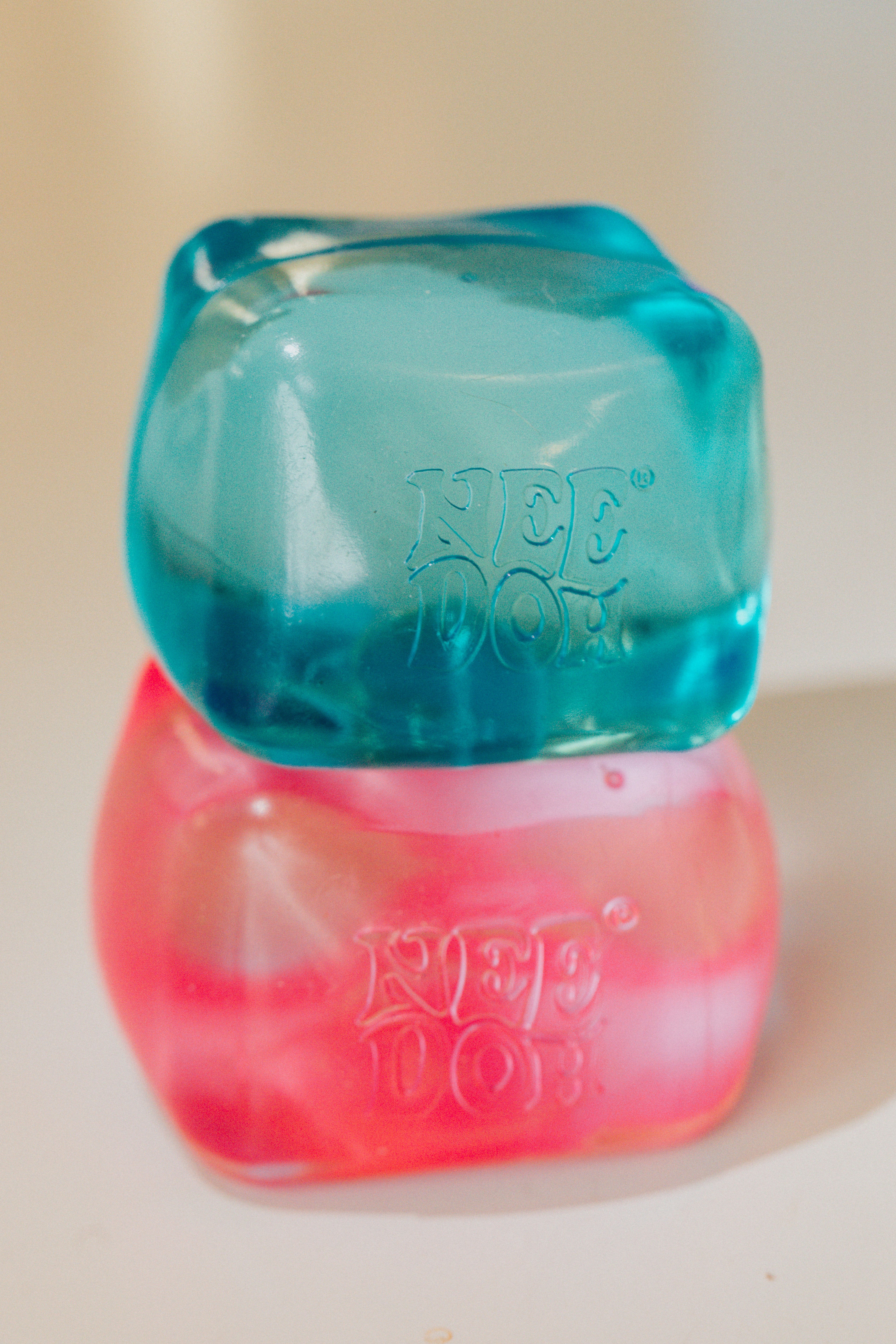 Stacked blue and pink needoh stress balls.