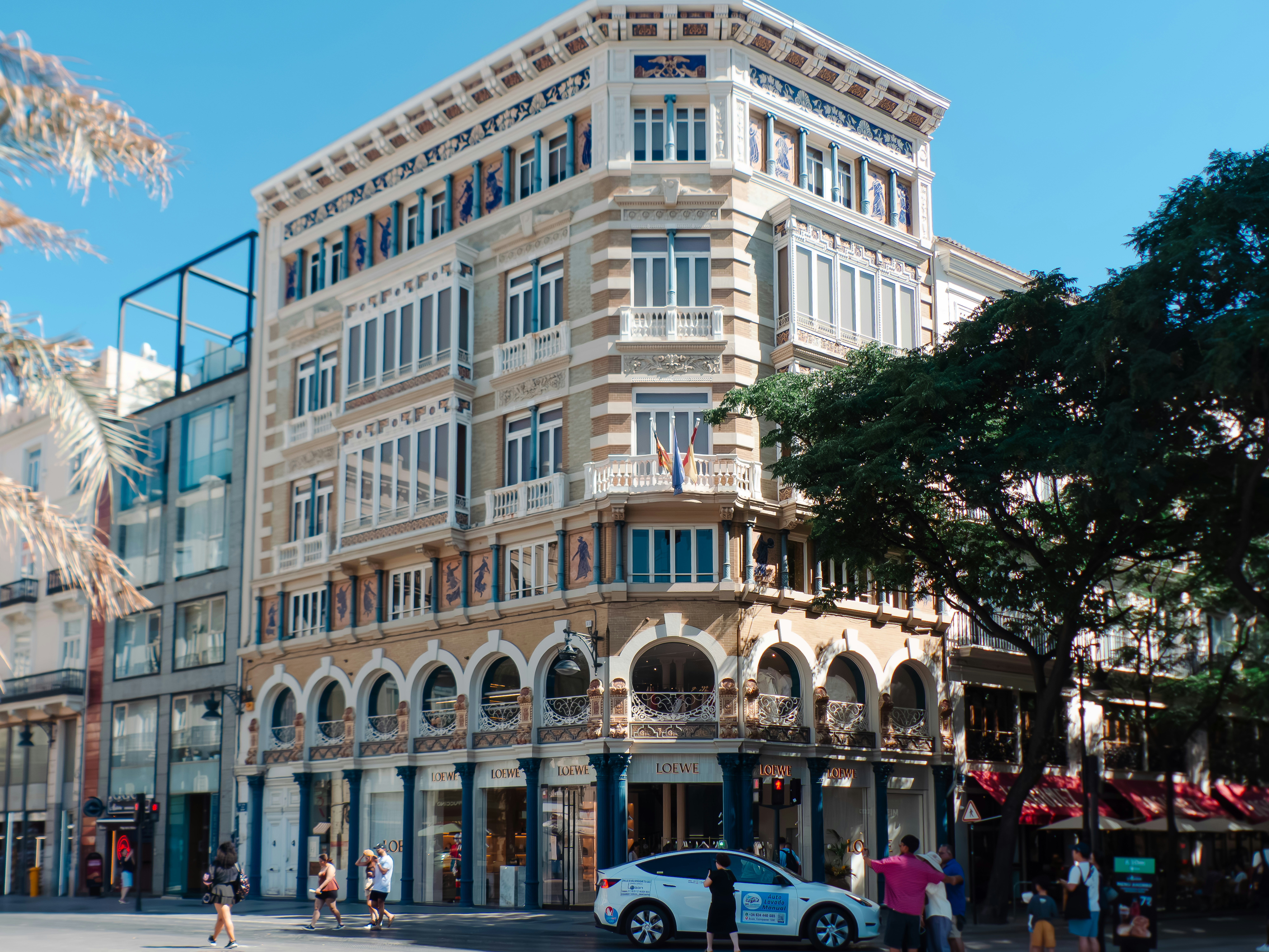 A historic building with ornate facade details on a sunny street in Valencia, Spain