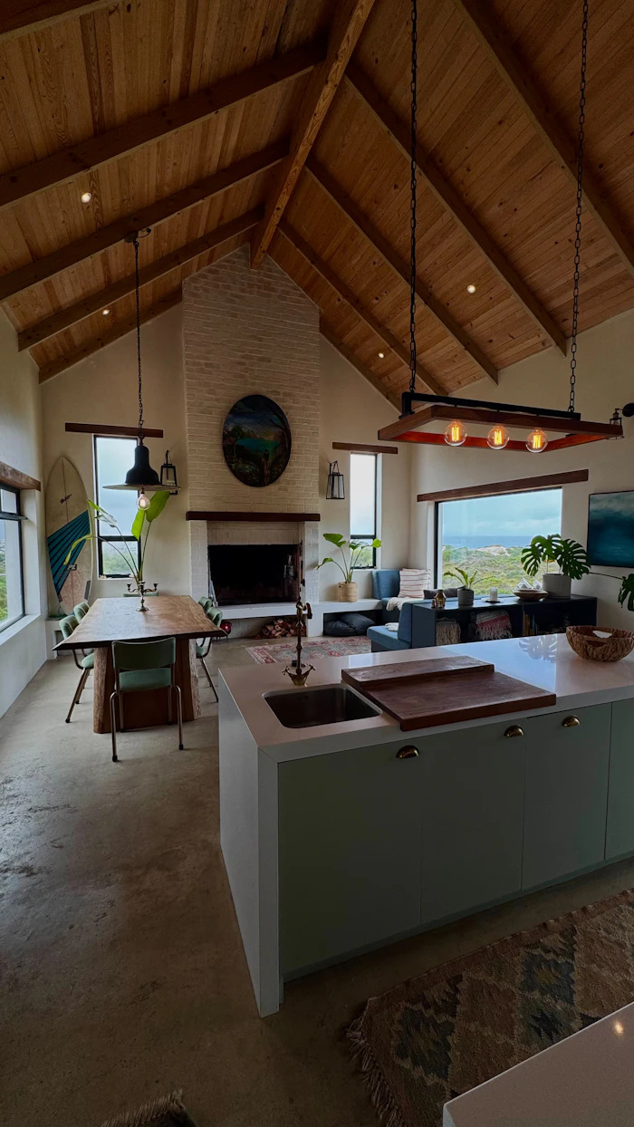 Open-plan living room and kitchen with a vaulted wooden ceiling
