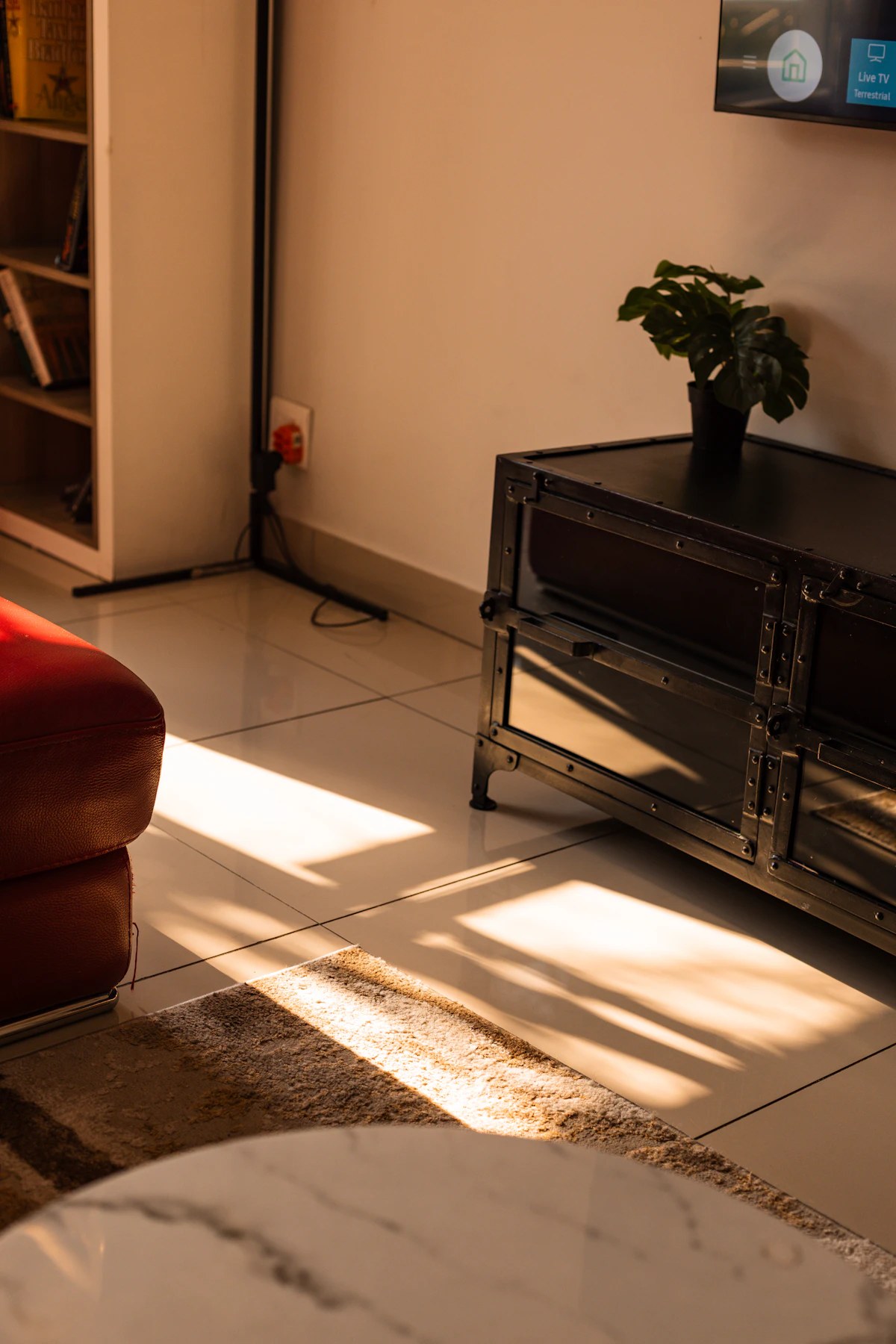 Closed box hiding chargers and cables in a small lounge
