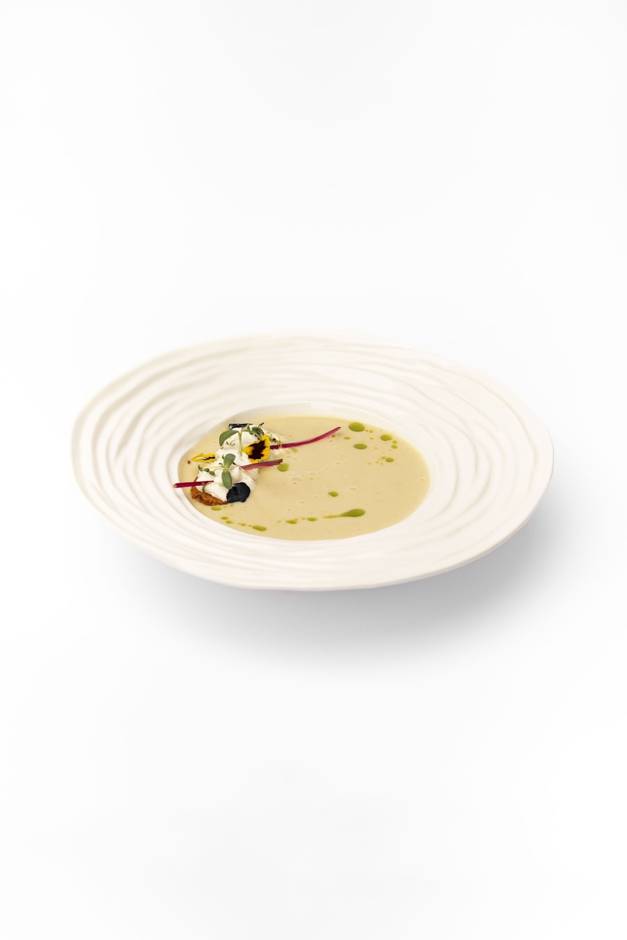 Creamy potato and leek soup in a white bowl