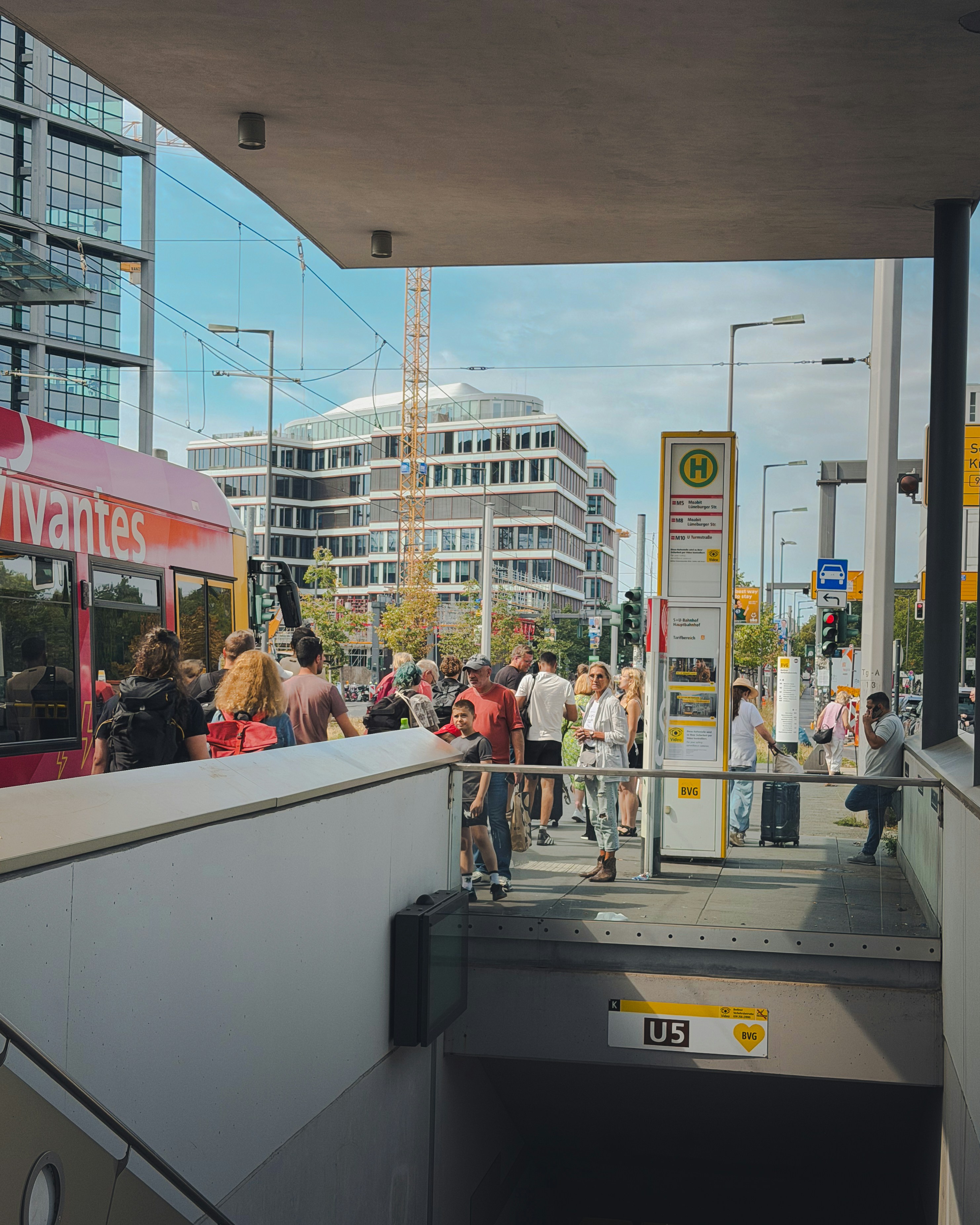 A group of people waiting for a tram at a city station