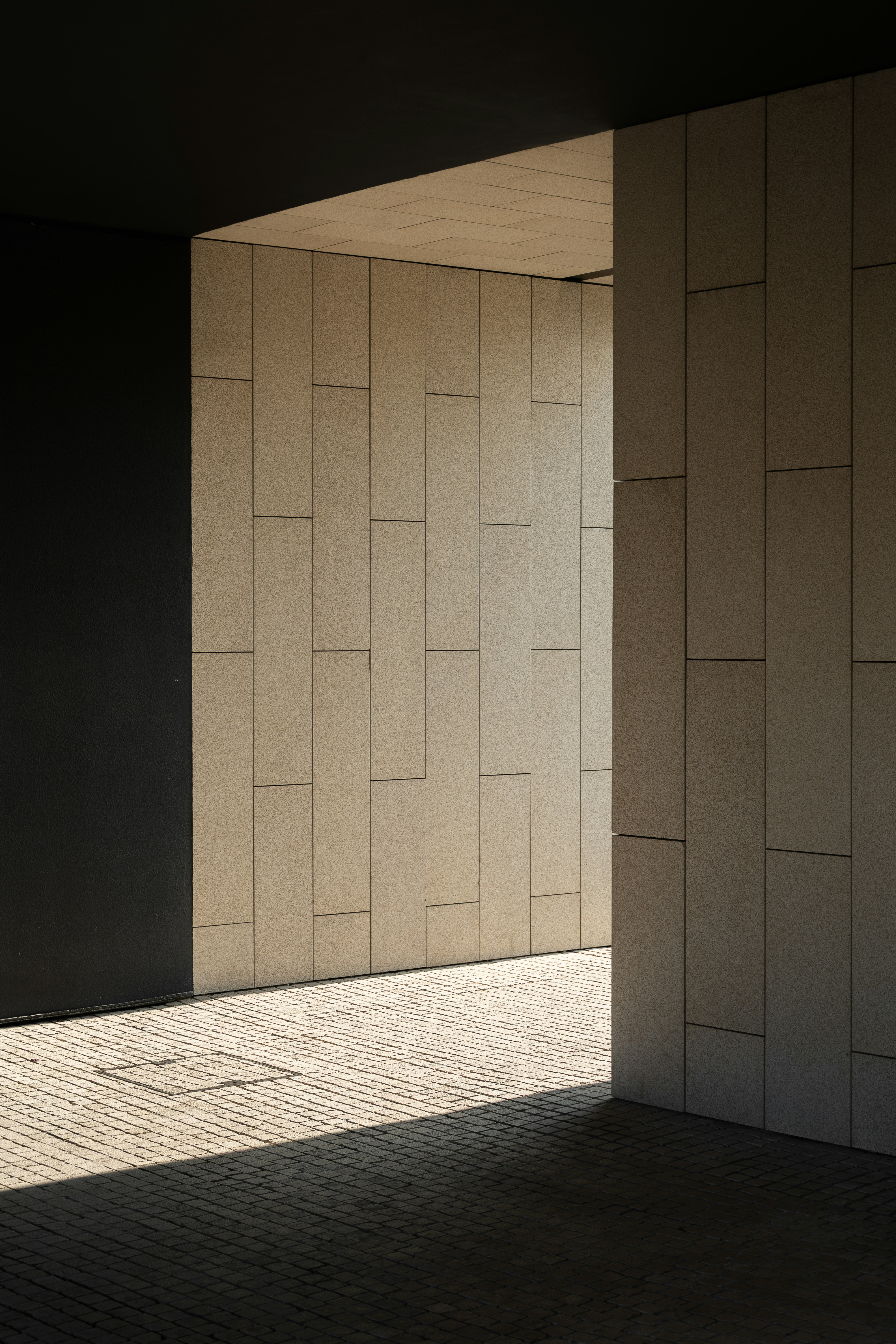 Geometric modern architecture with contrasting light and shadow.