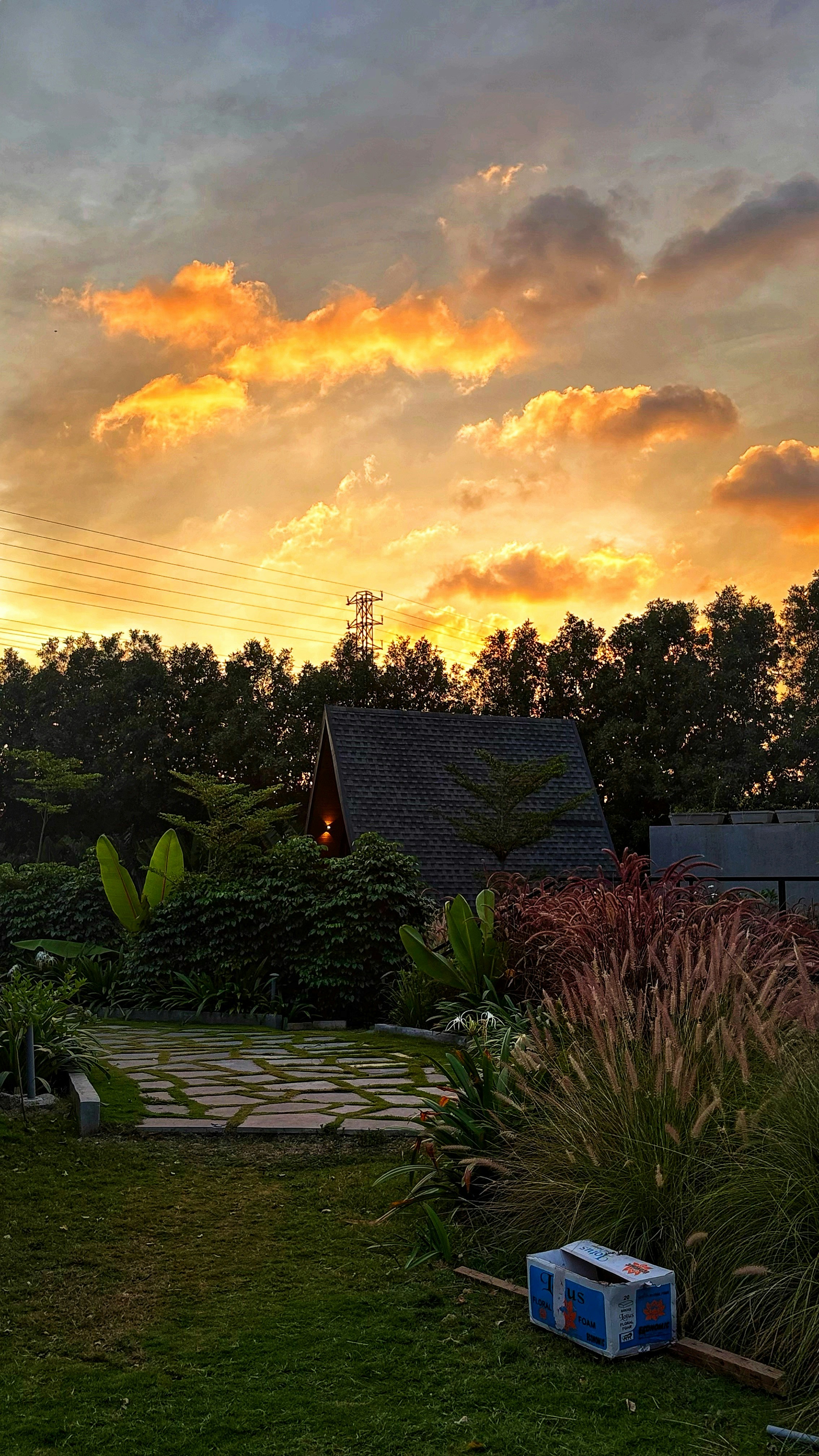 Vibrant sunset over a cozy cabin in a green garden