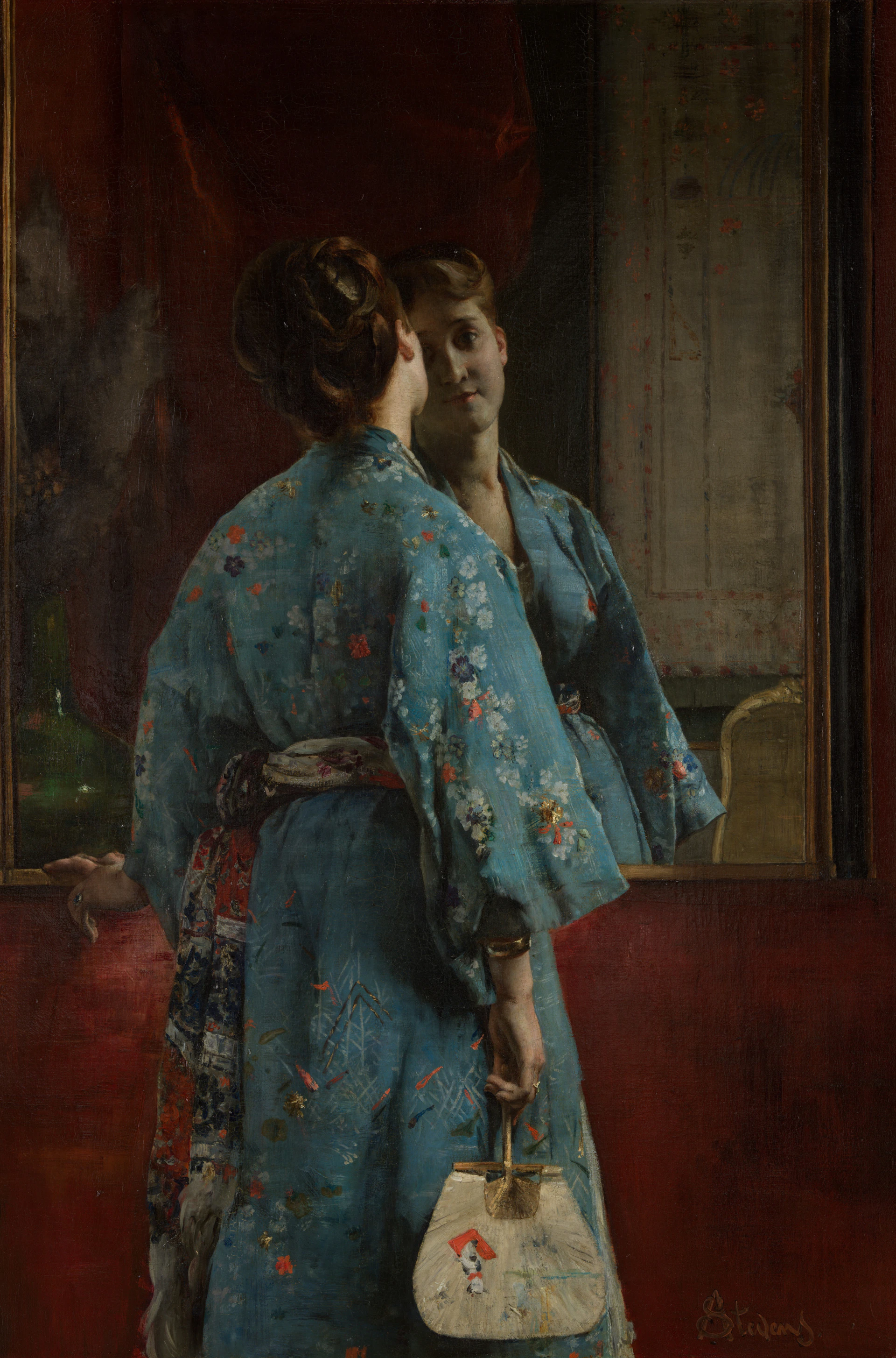 Elegant woman in blue kimono admiring reflection in a mirror
