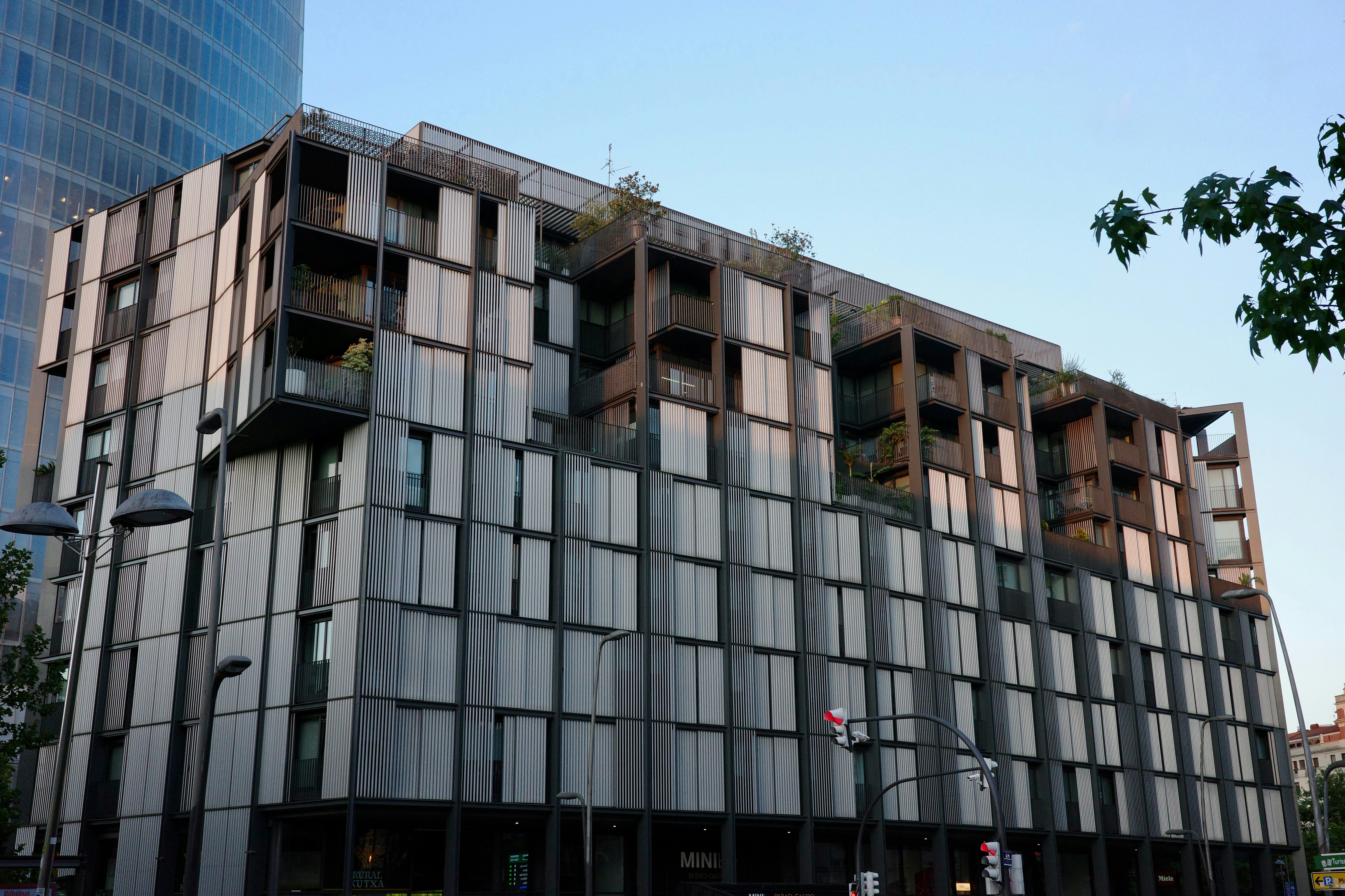 A modern building with a unique facade and rooftop gardens