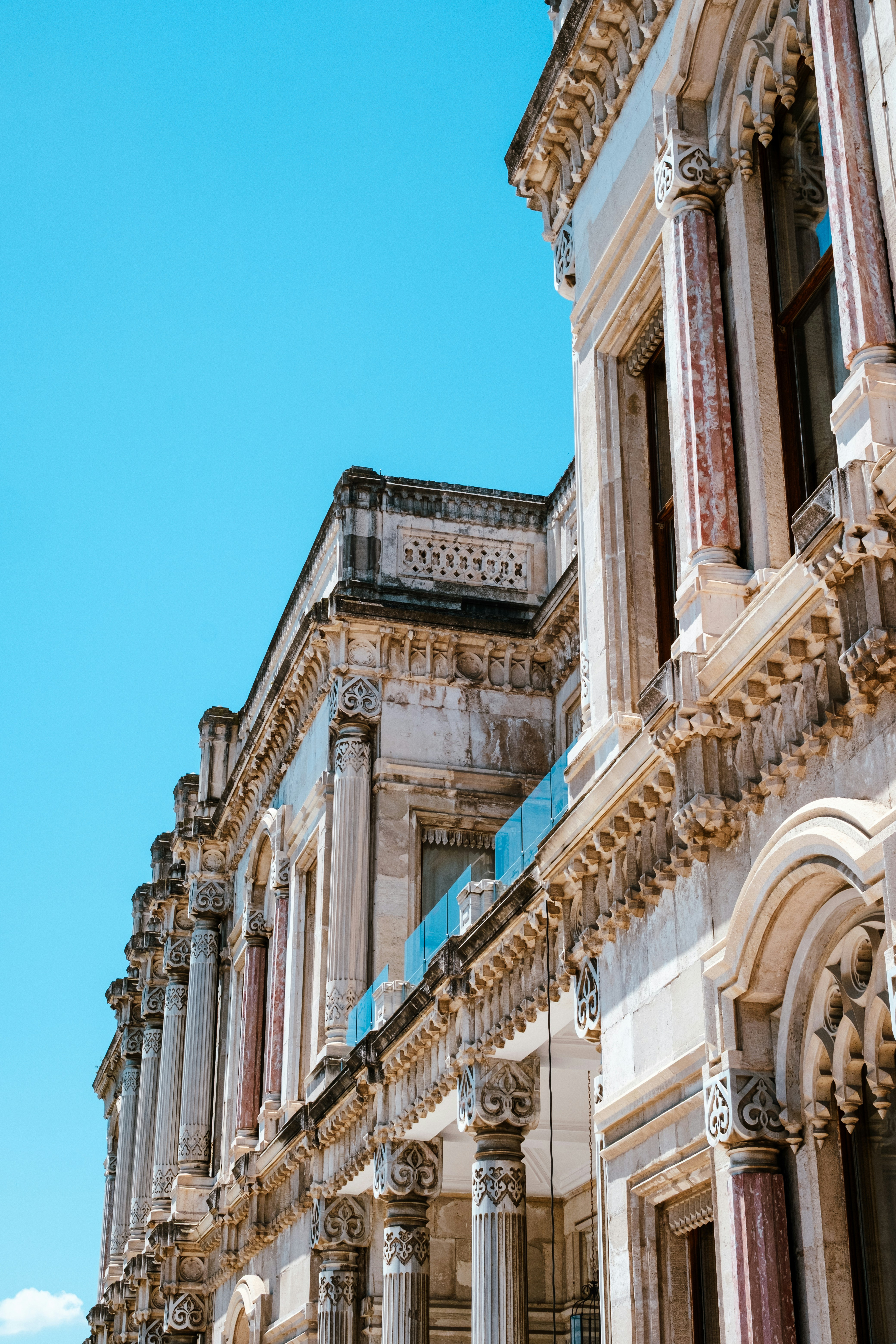 Ornate classical building with columns against a clear blue sky