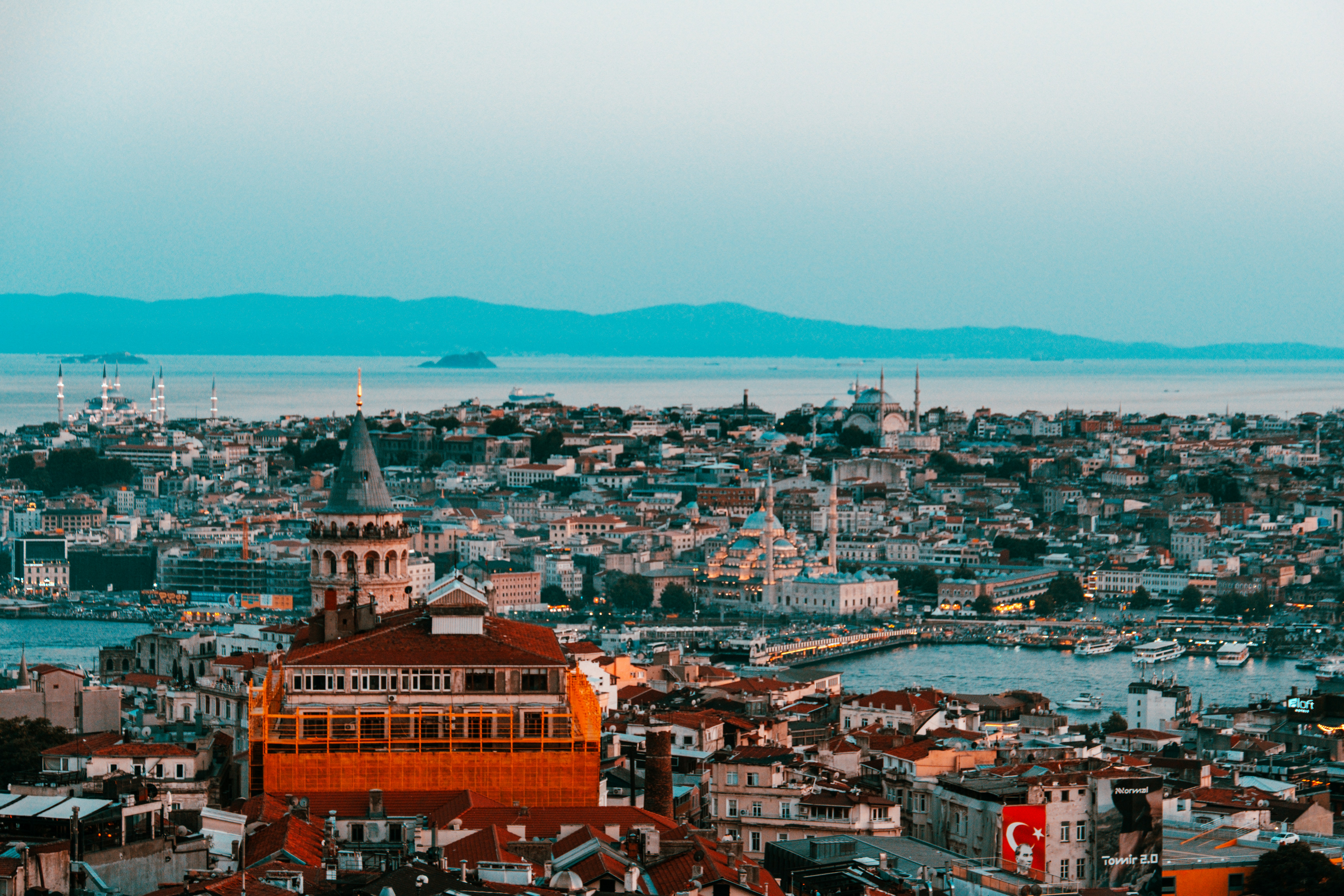 Istanbul cityscape with galata tower, bosphorus, and distant mountains
