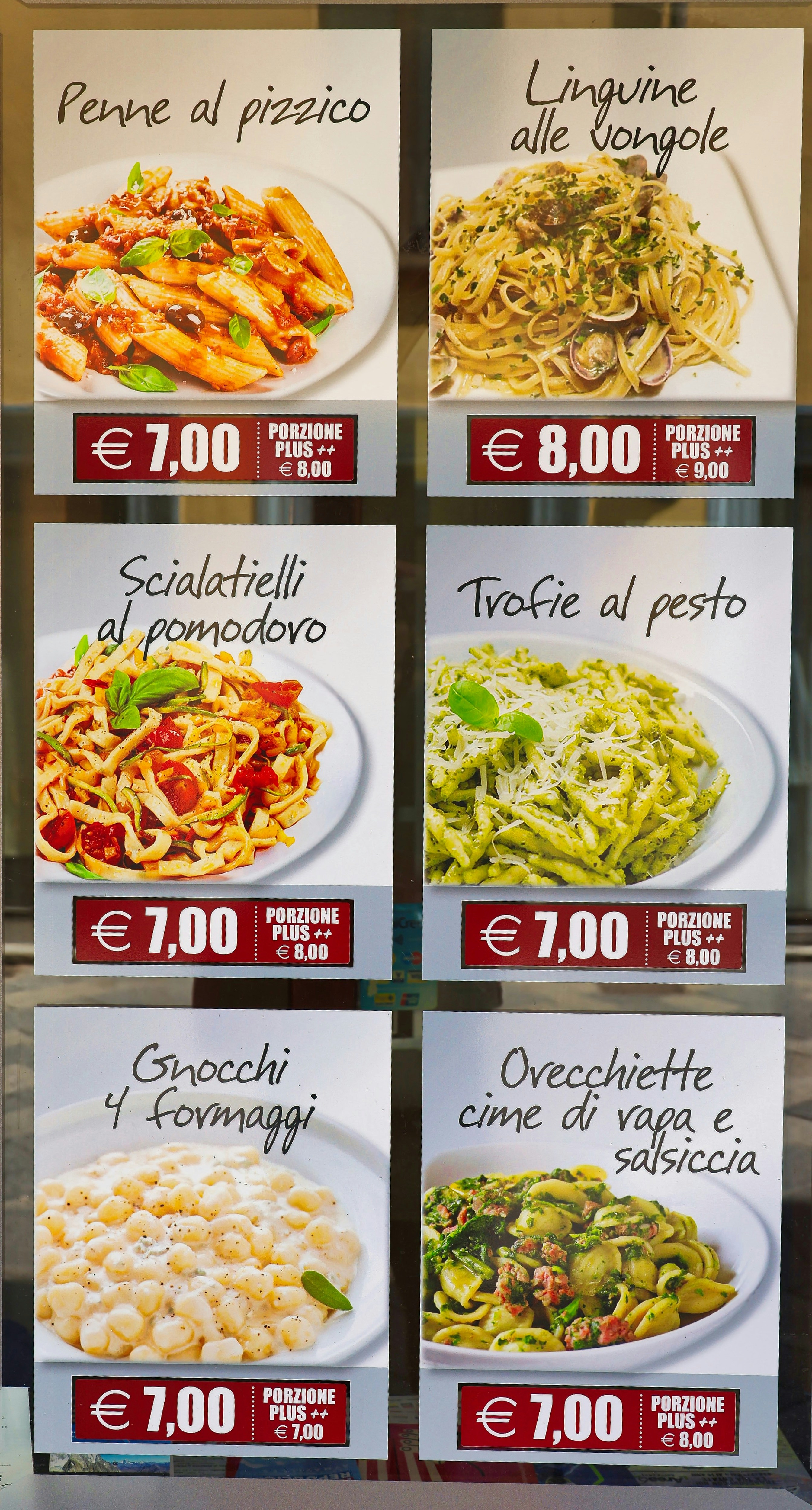 A menu board displaying various italian pasta dishes with prices