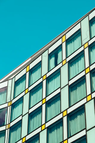 Modern building facade with square windows against a blue sky