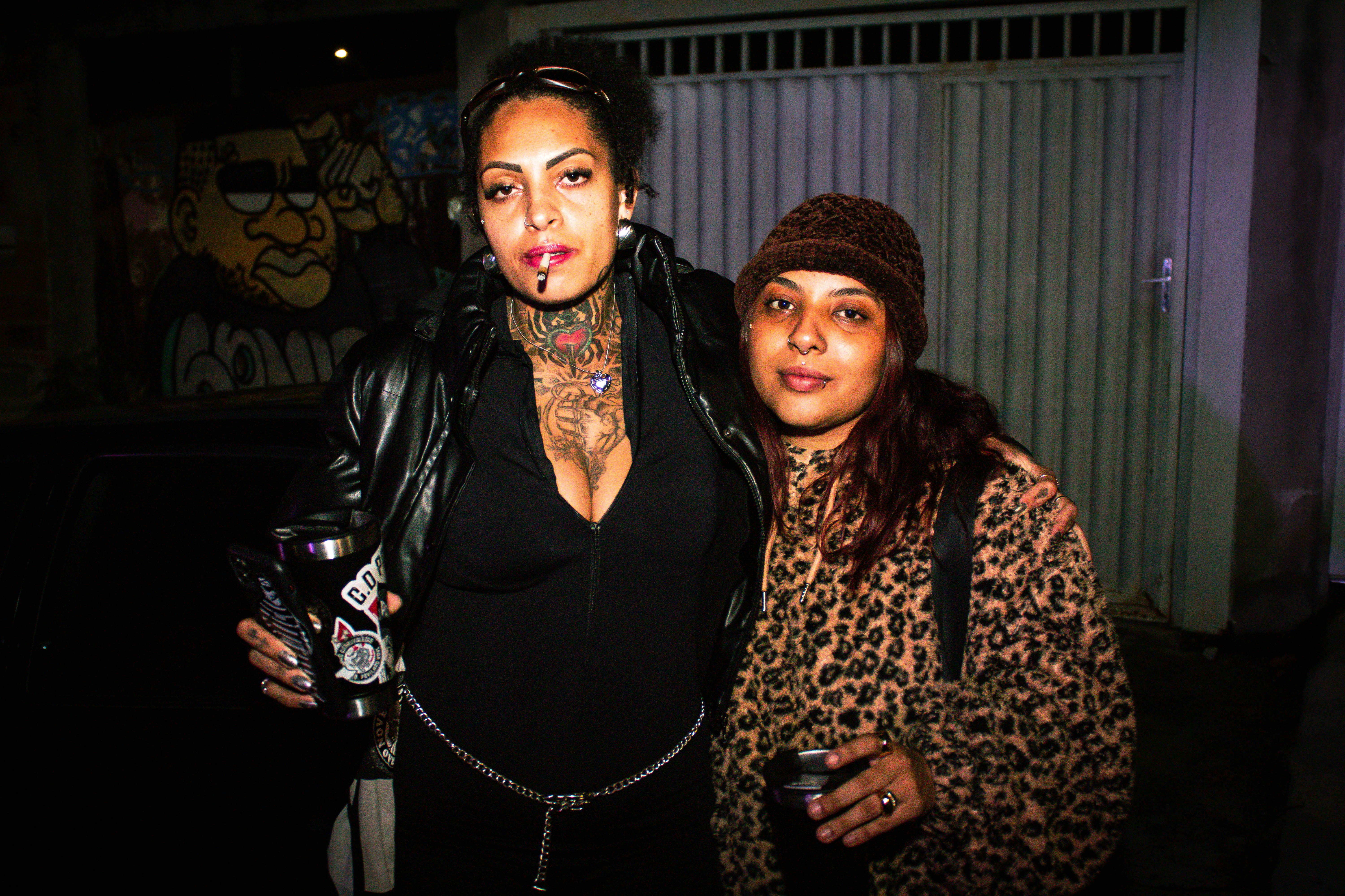 North by Northwest and Iconic Collaborations — Tattooed woman smoking next to friend in leopard print