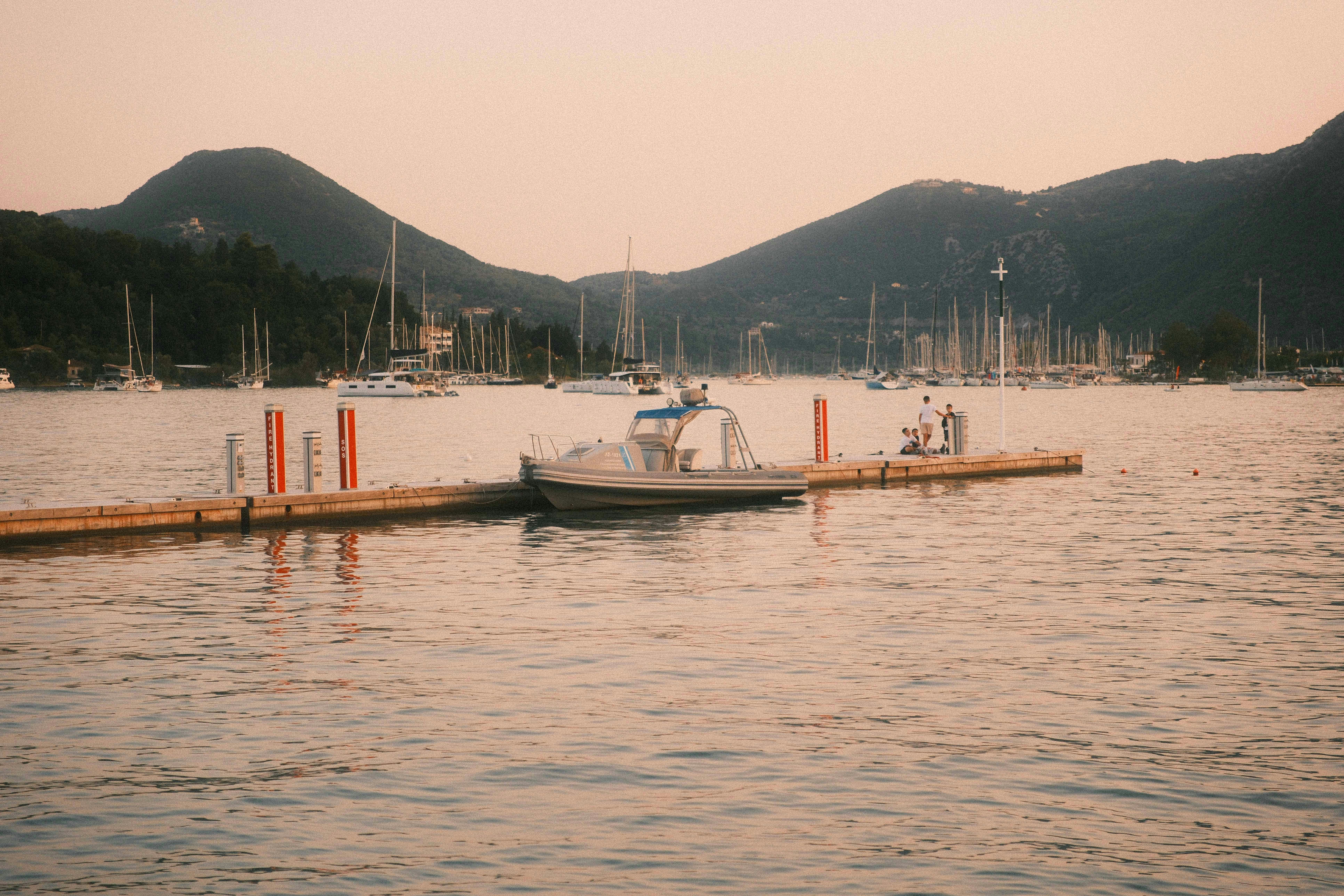 Sunset over a bay with boats docked at a pier