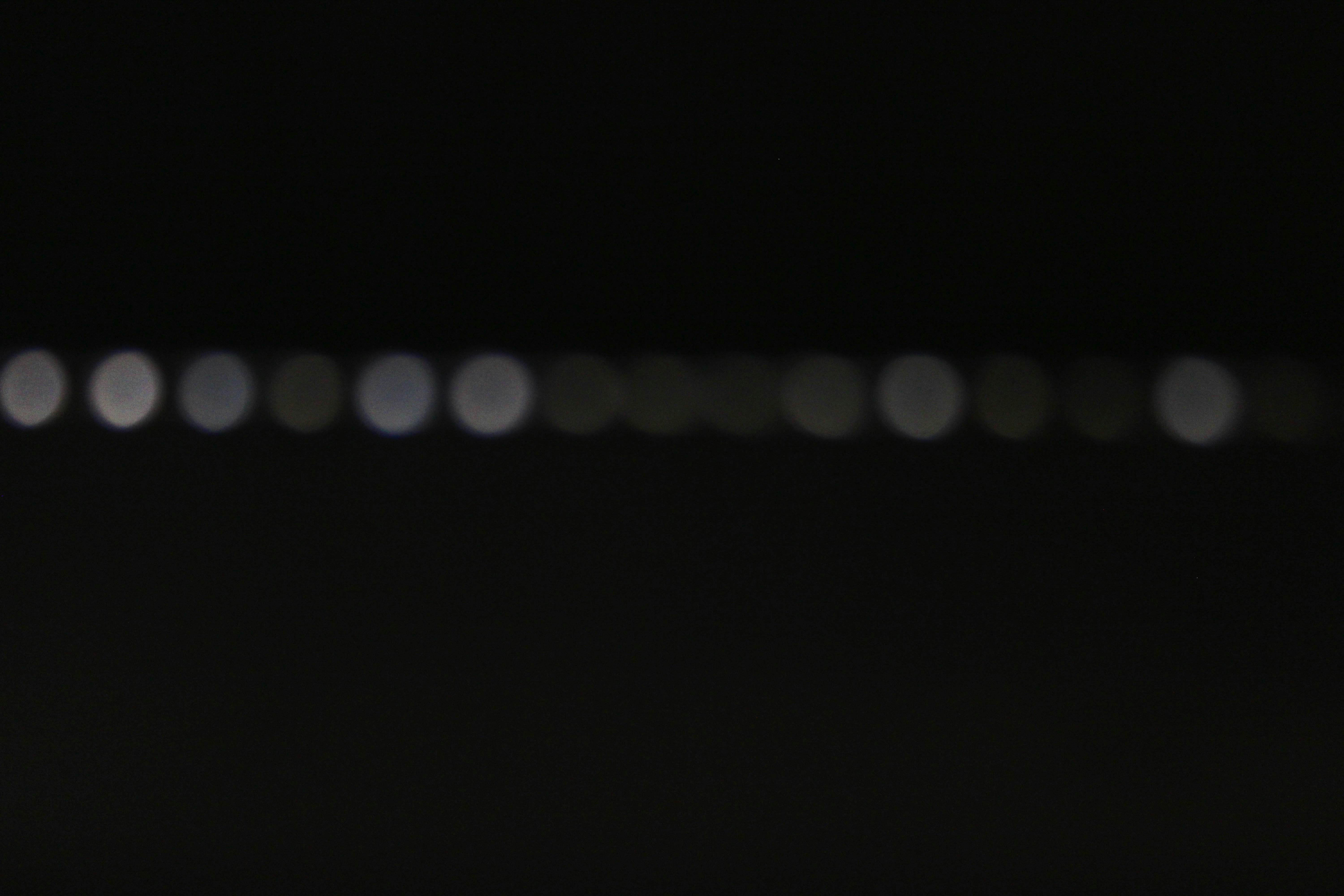 Blurred white and grey lights on a dark background.