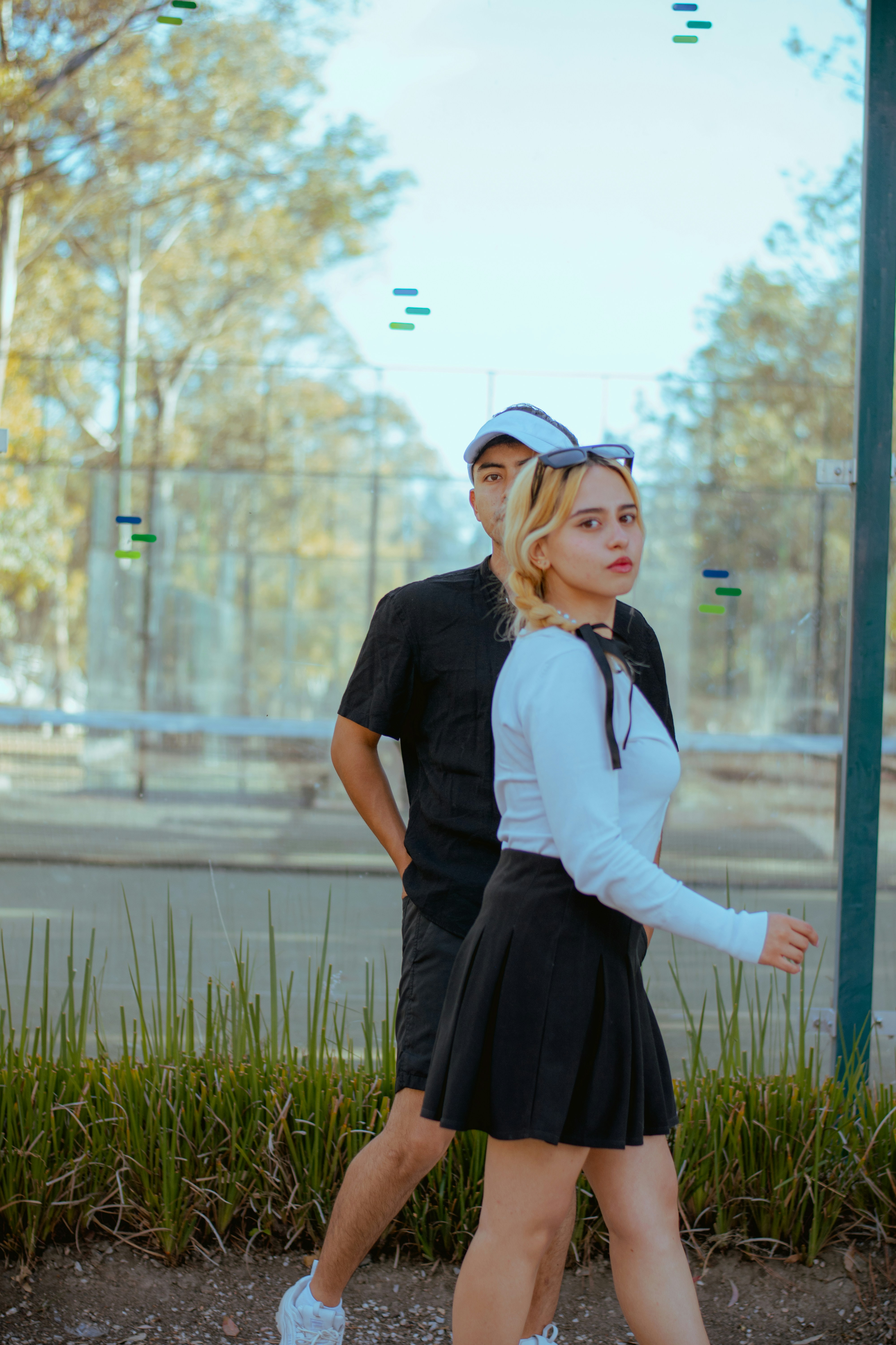 A young woman looks back while walking with a man