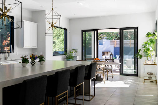 Modern kitchen with large island, bar stools, and outdoor patio