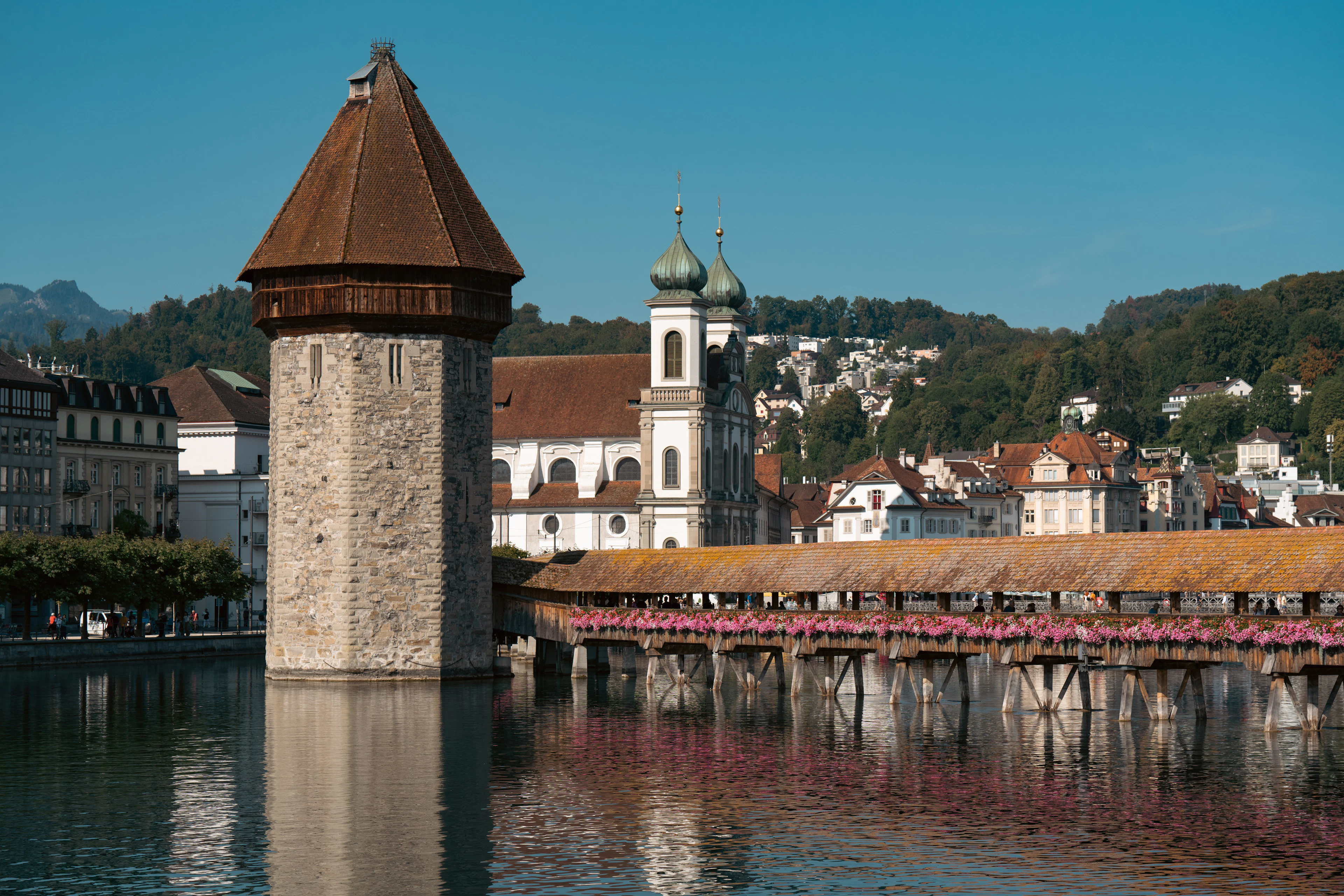 The Chapel Bridge and its octagonal water tower on the Reuss at Lucerne, the town rising behind