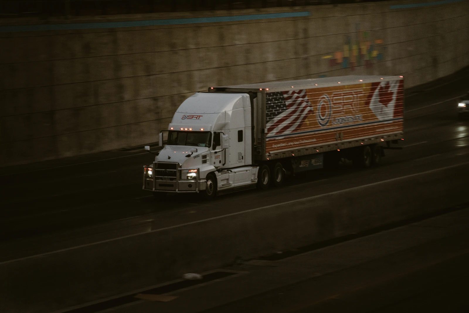 A white truck travelling along a highway