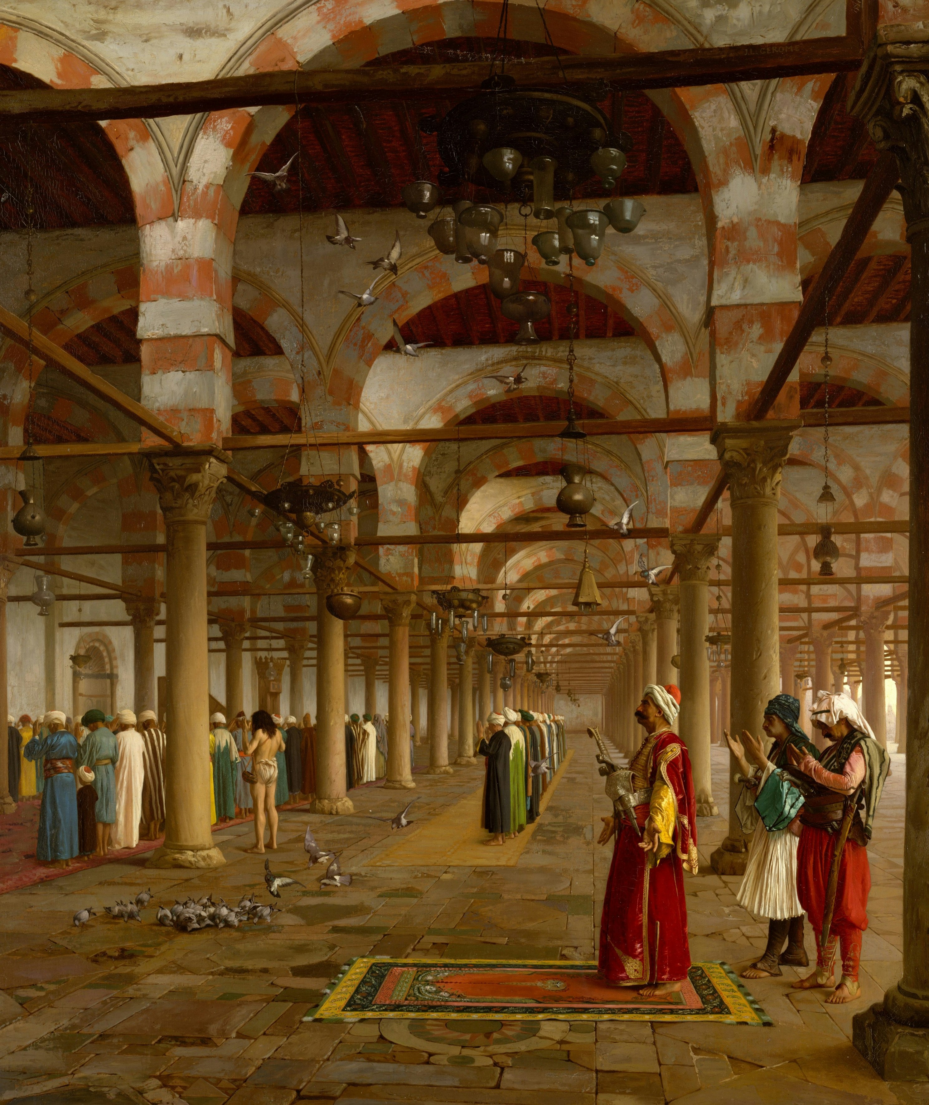 People praying in a mosque with striped arches, stone columns, and flying pigeons.