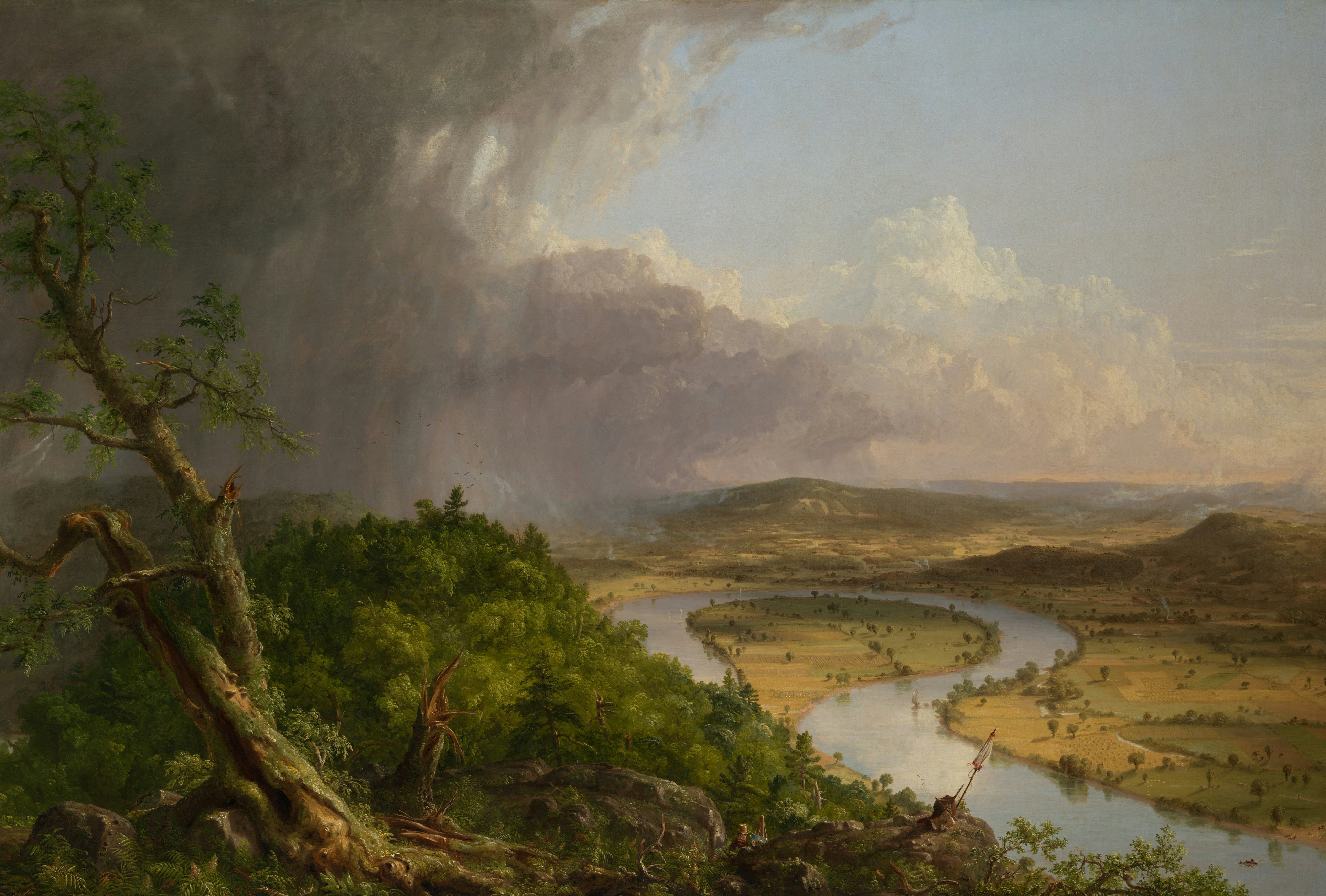 A winding river through a valley under a dark, stormy sky.