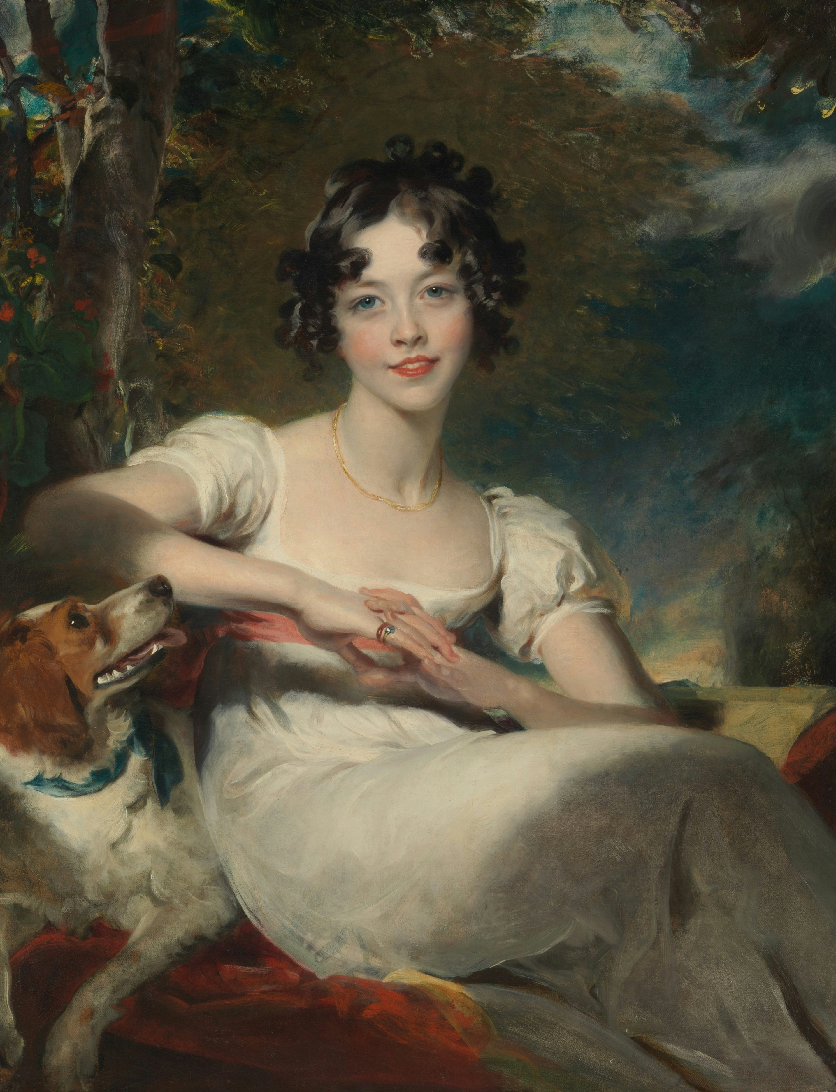 A woman in a white dress with a dog in a wooded landscape.
