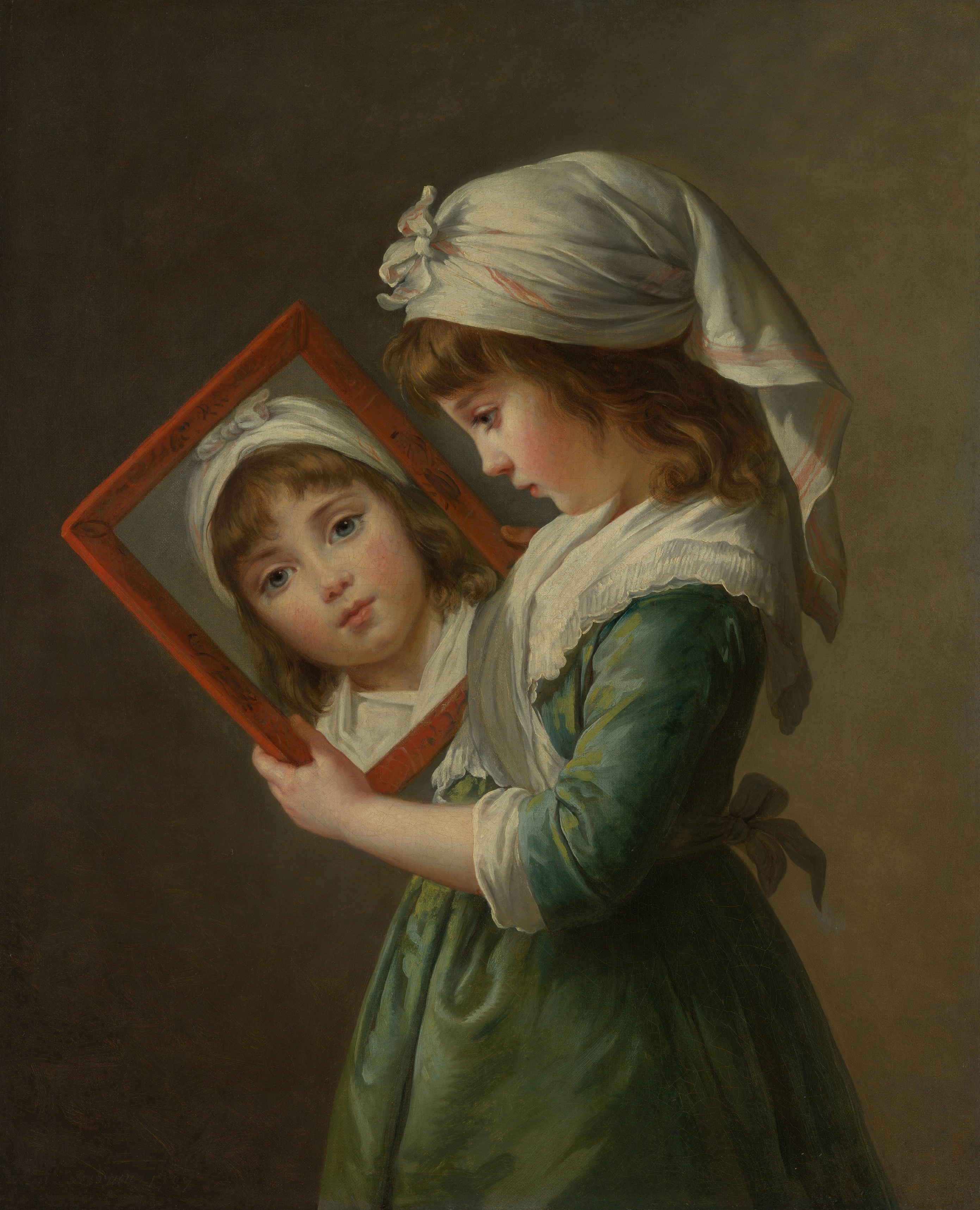 A child in a green dress and white headscarf holding a framed mirror.