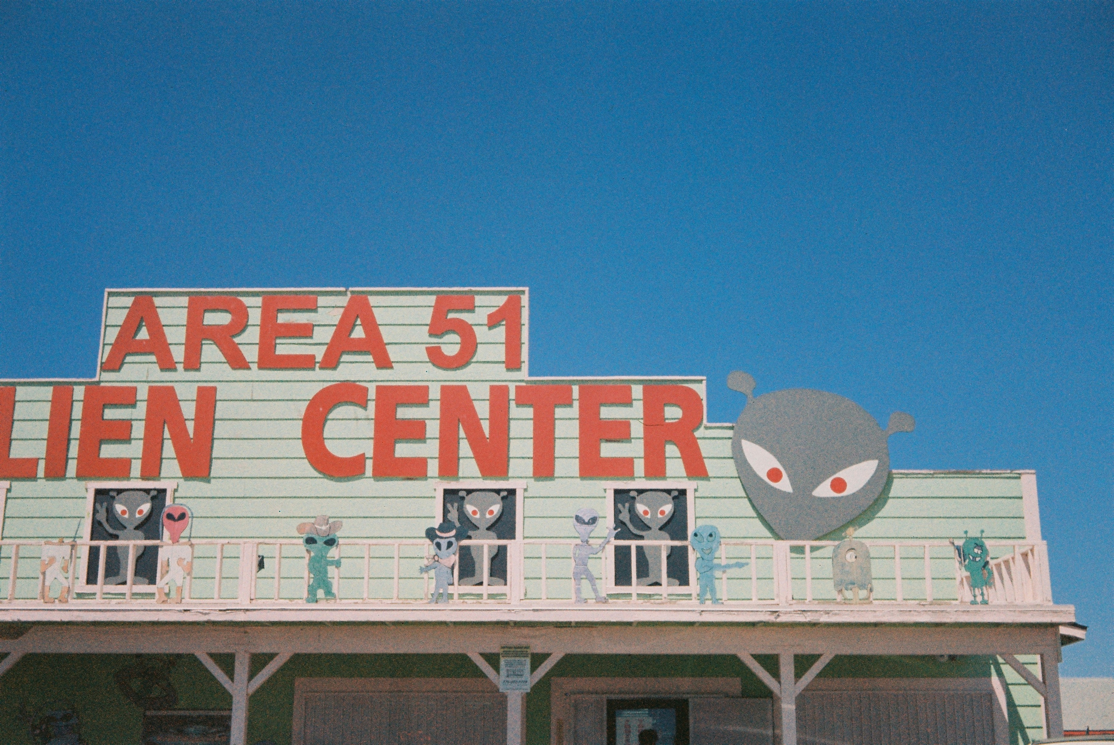 The Area 51 Alien Center building with alien cutouts on a balcony.