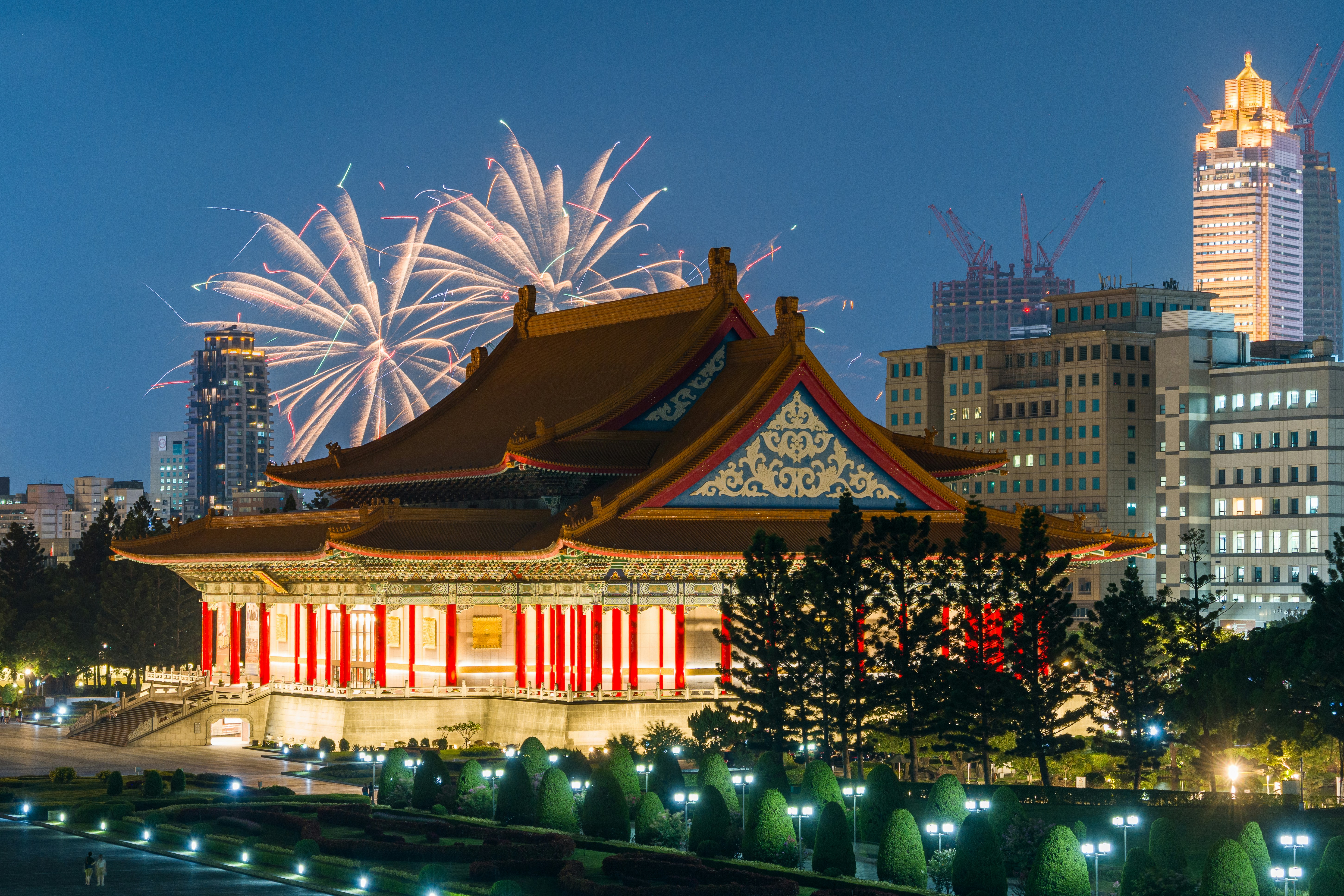 Fireworks exploding over the National Theater in Taipei at night.