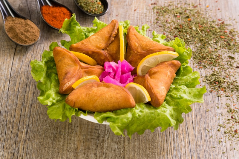 Golden fried Tunisian brik pastry served with a lemon wedge