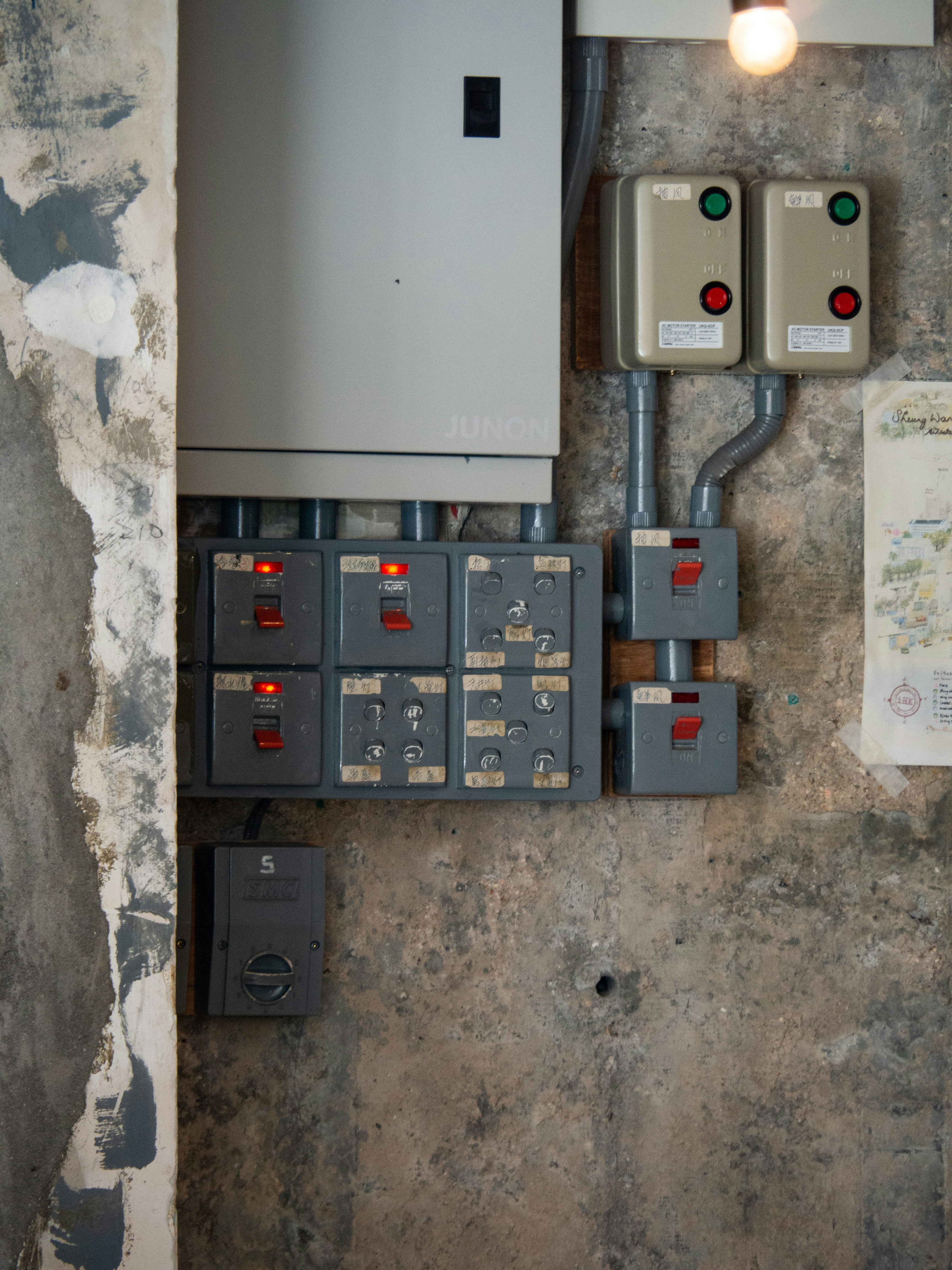 Industrial electrical control panel with switches installed on a concrete wall