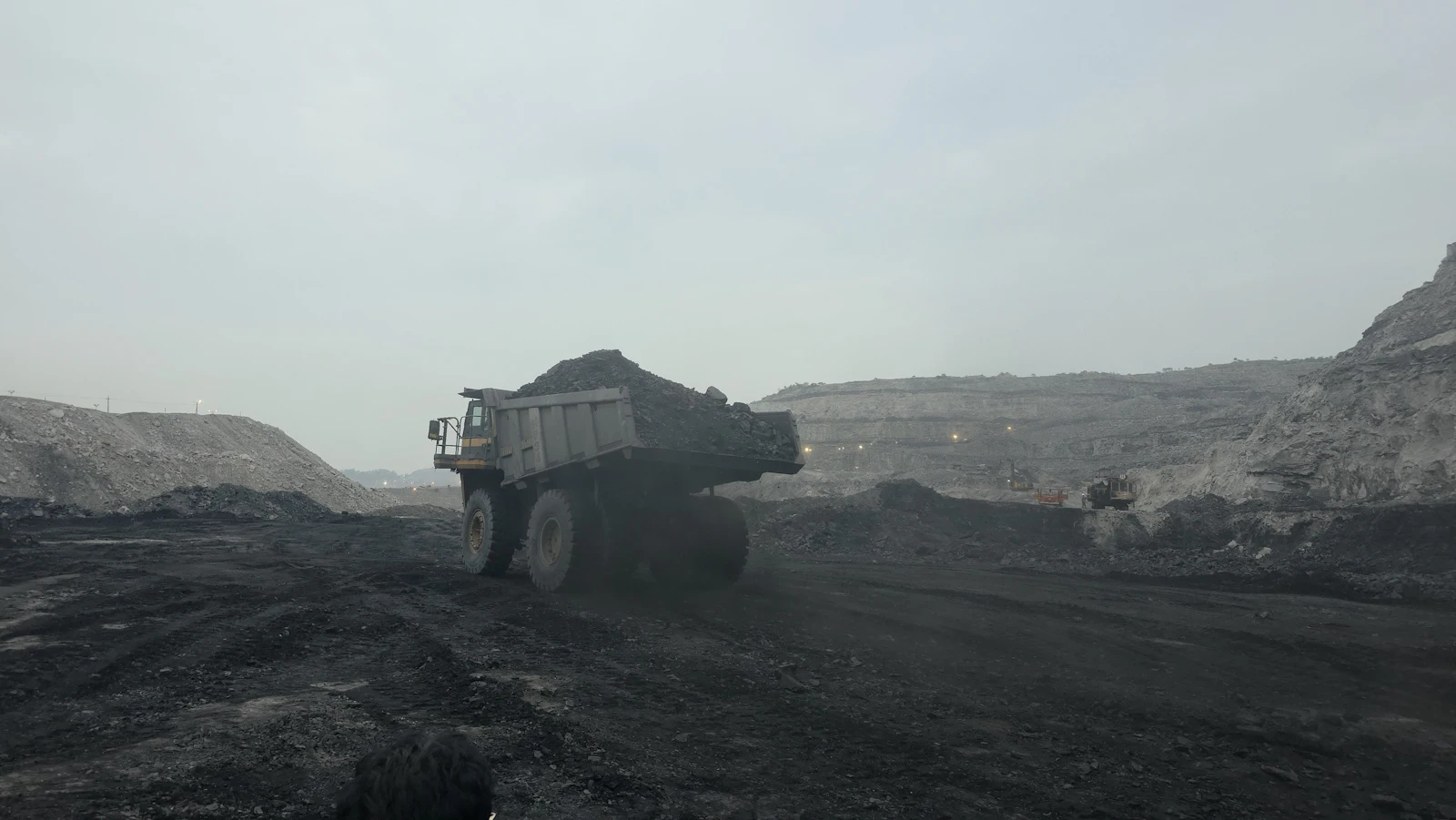 Haul truck carrying ore through an open-pit mine