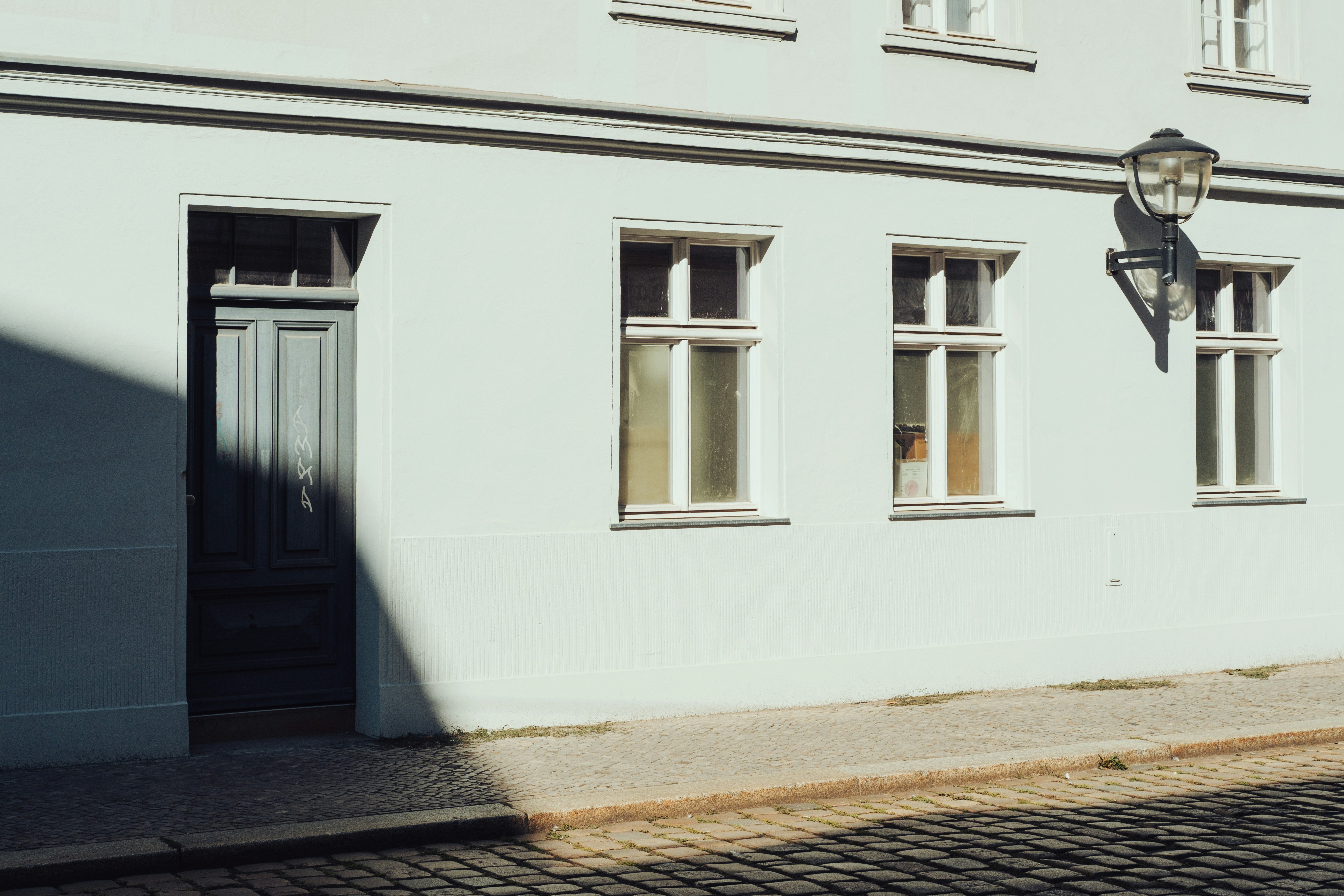 A grey door and windows on a white building in Brandenburg, Germany.