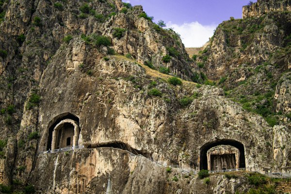 Ancient rock-cut tombs carved into a steep cliff face in Amasya, Turkey