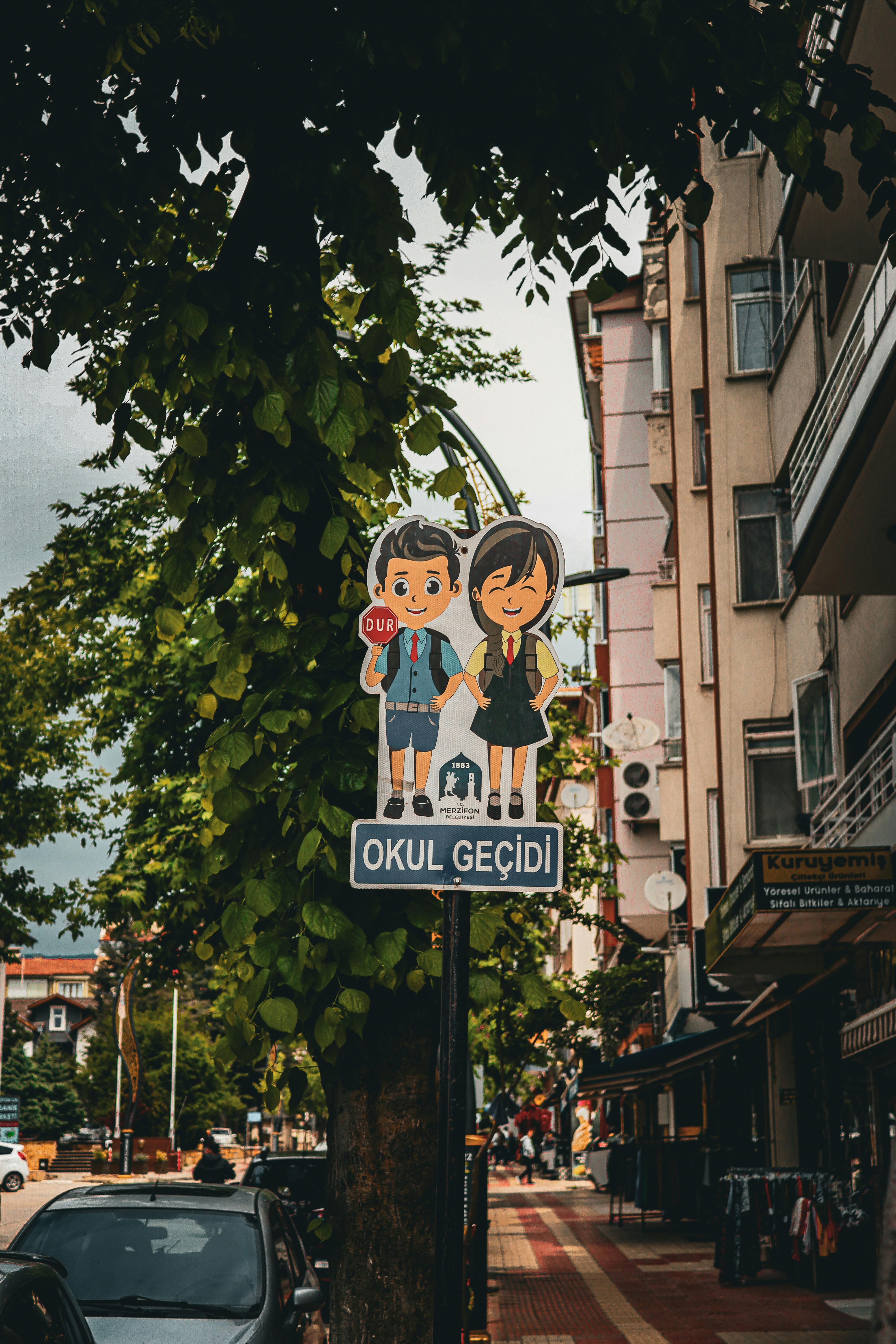 A school crossing sign with cartoon children on a street in Merzifon, Turkey.
