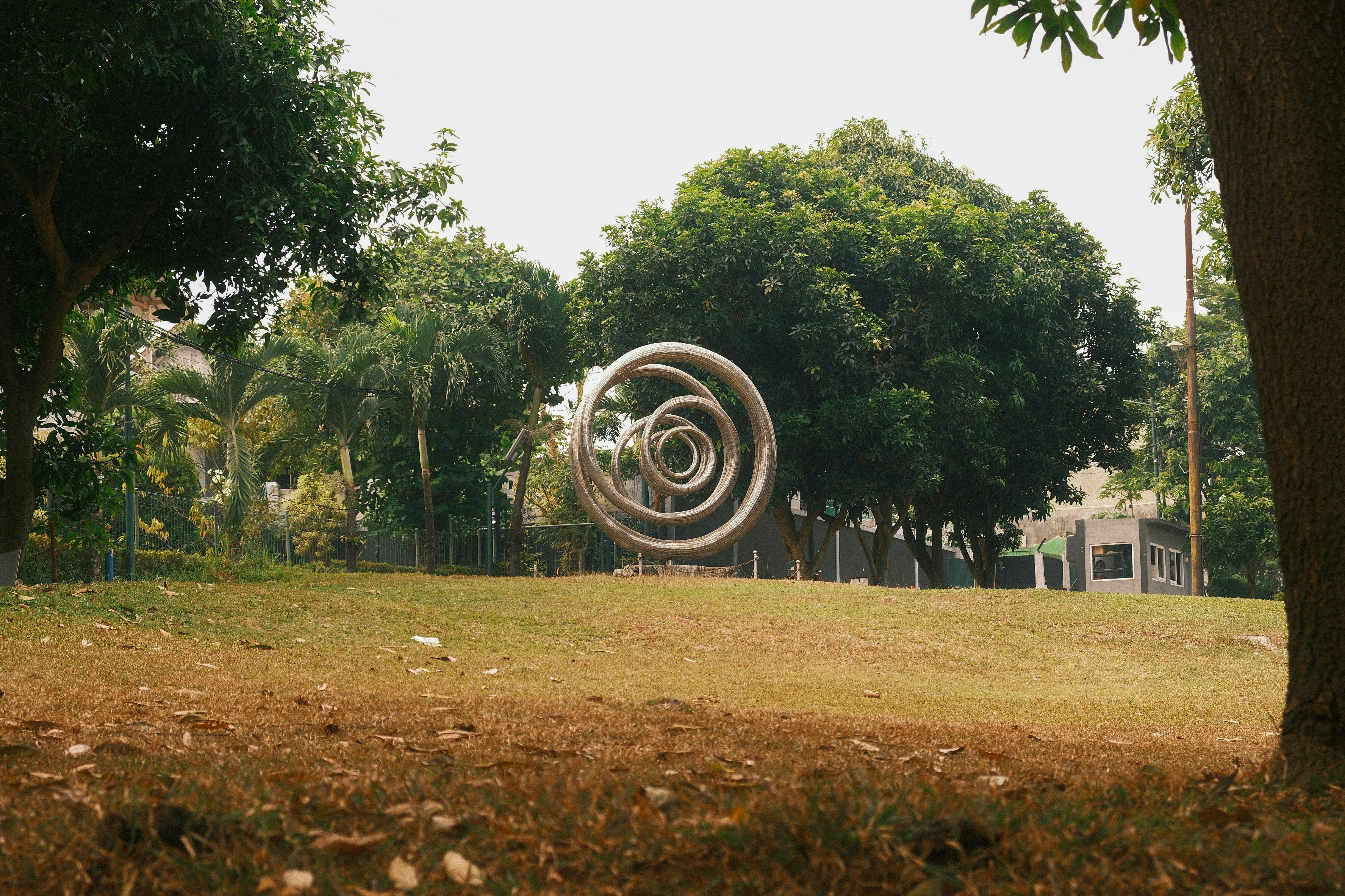 Metallic spiral sculpture on grassy hill - Free Photo on Unsplash