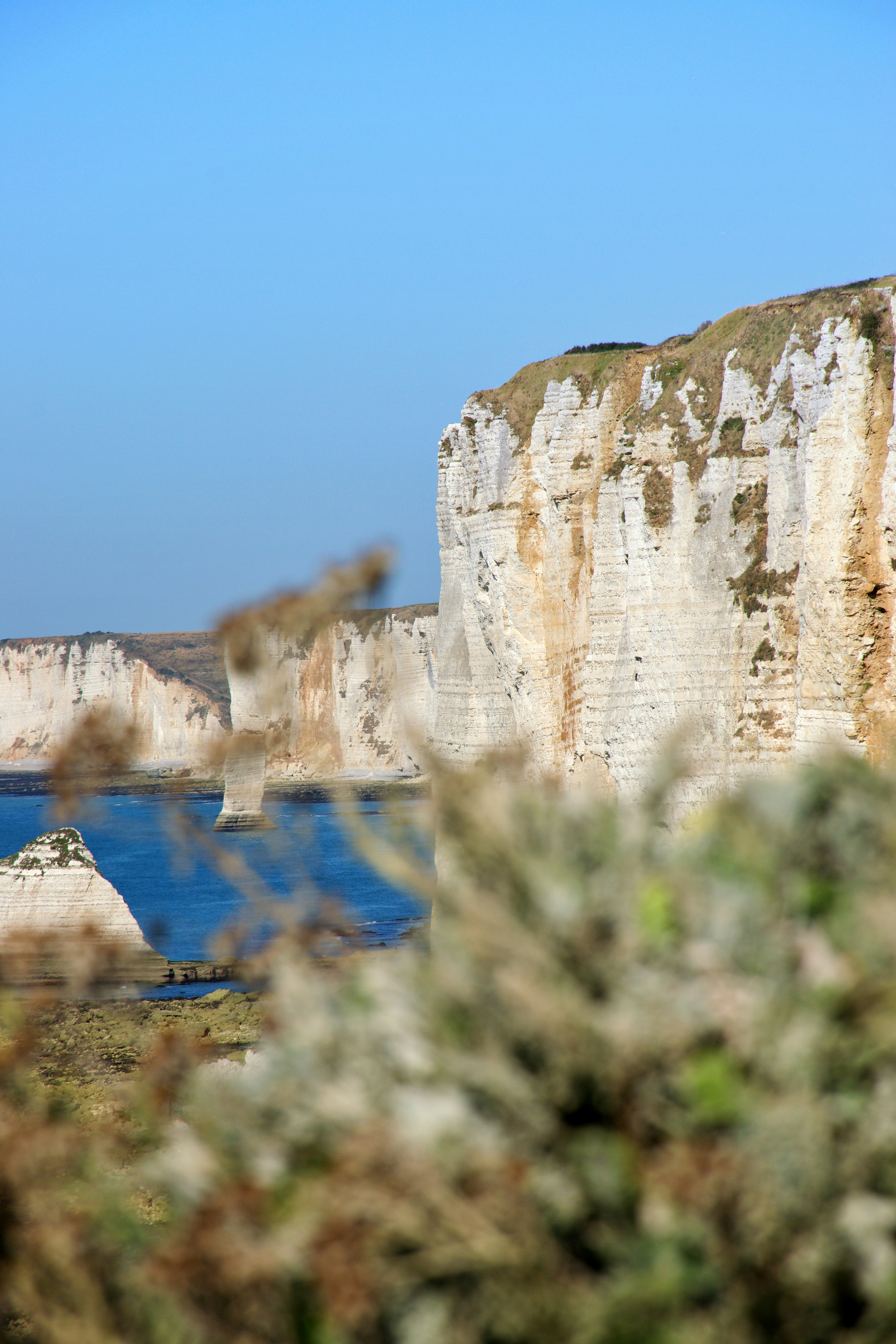 White chalk cliffs rising above the blue sea in Etretat, France