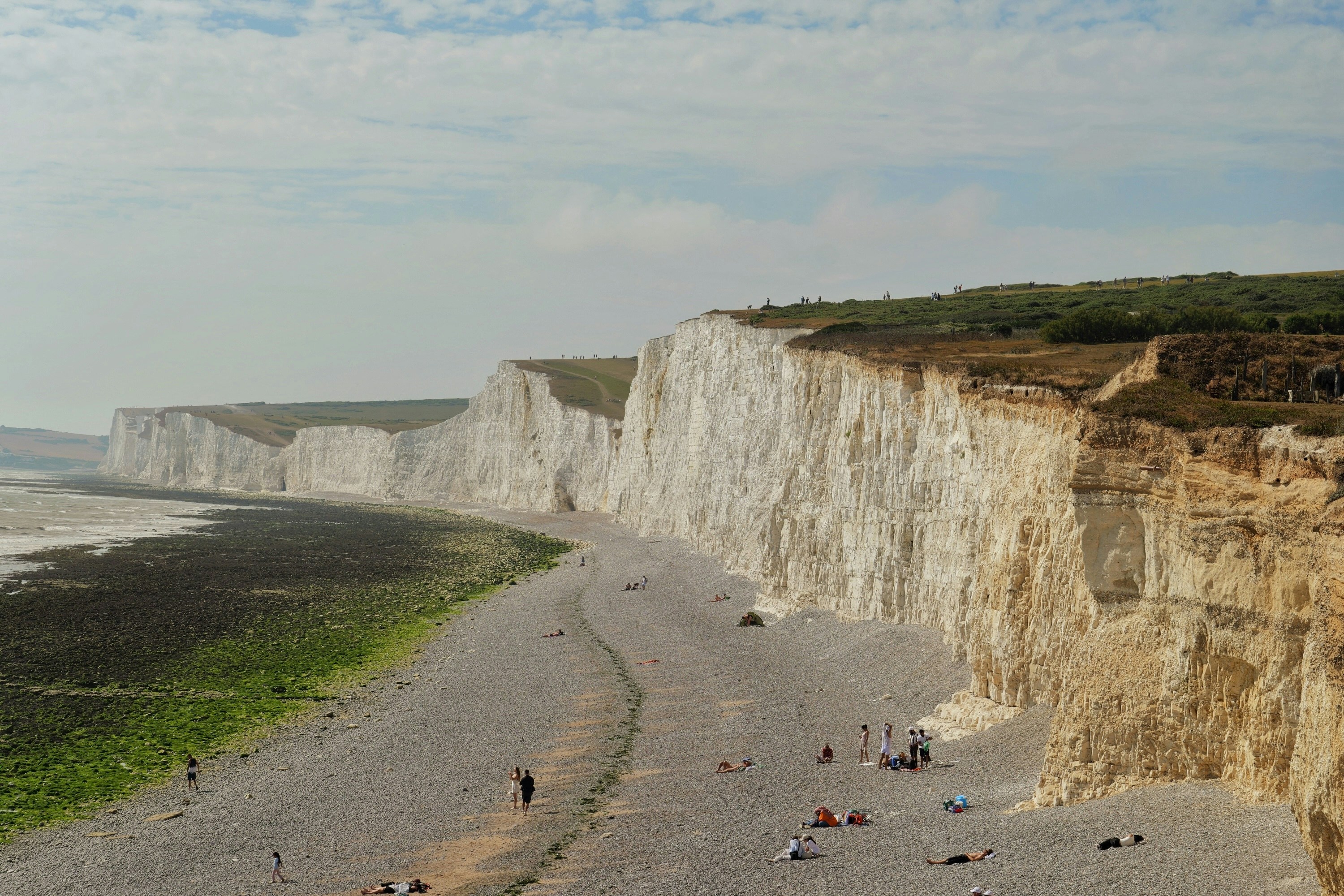 The Seven Sisters white chalk cliffs above a pebble beach in East Sussex, England