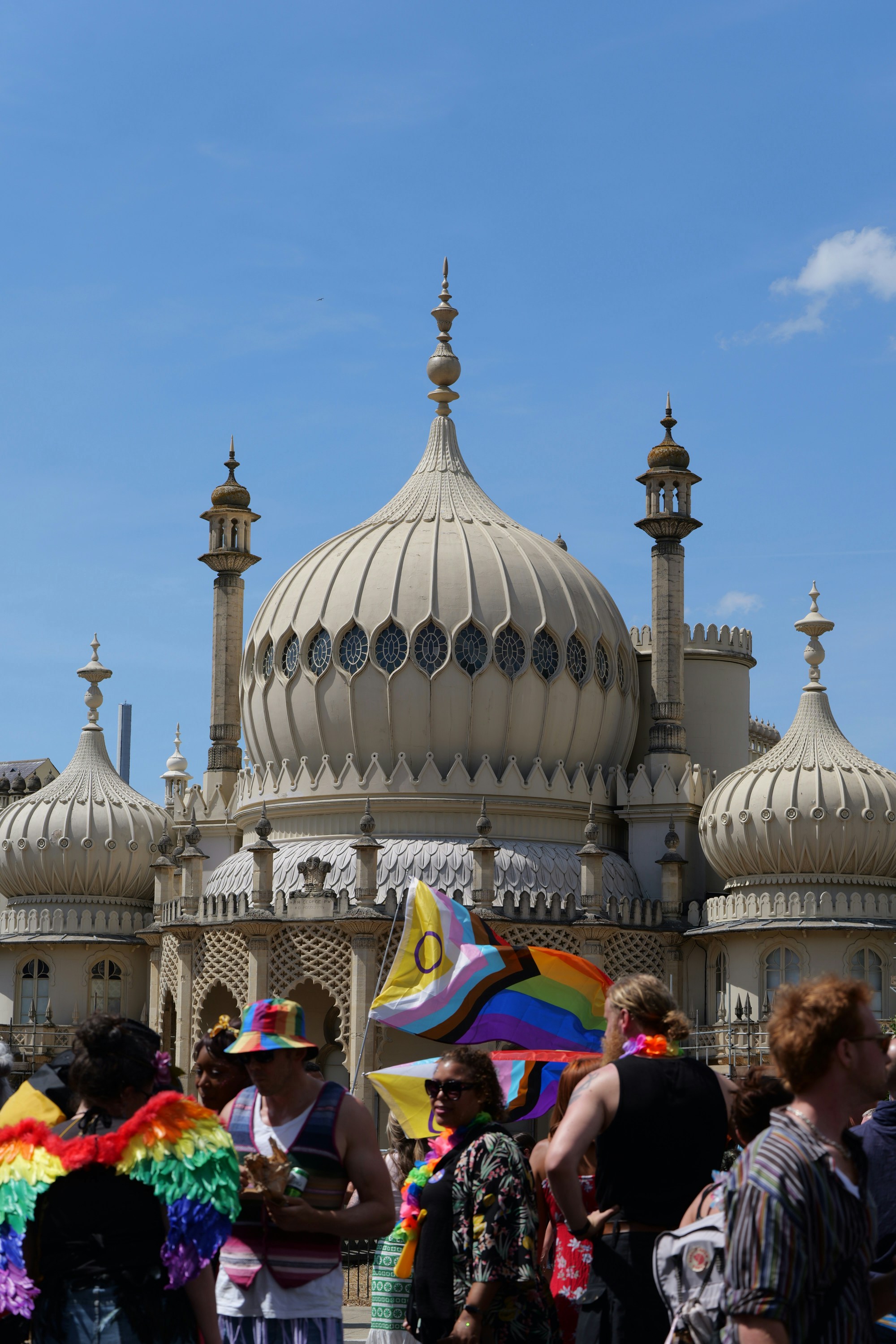 People with pride flags in front of the Royal Pavilion in Brighton