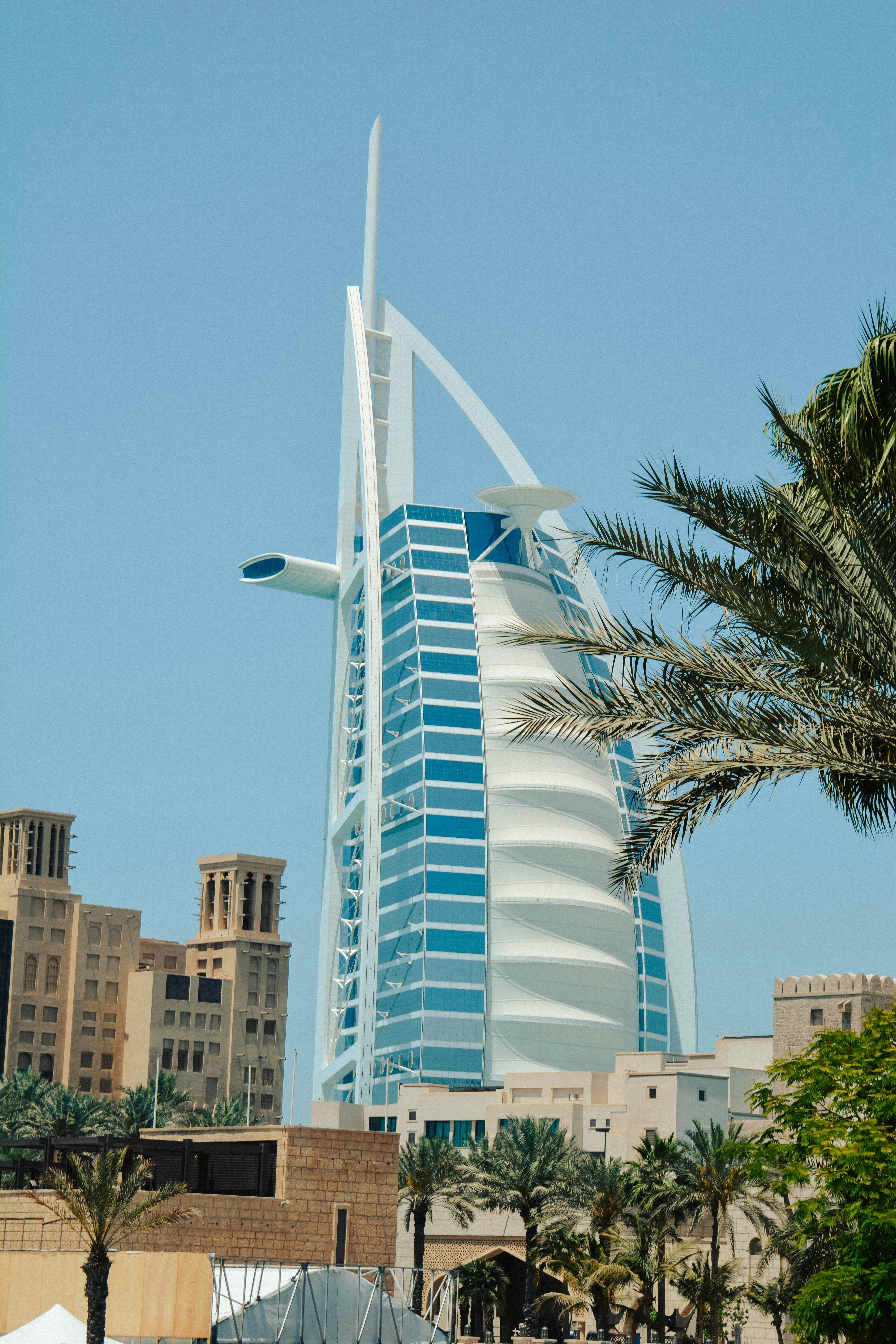 The Burj Al Arab hotel in Dubai with palm trees and traditional architecture