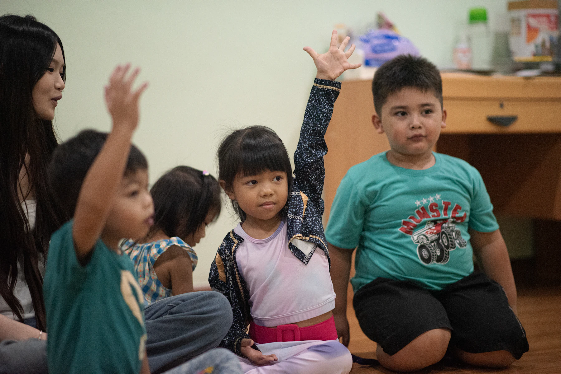 Children raising their hands during a kids worship time