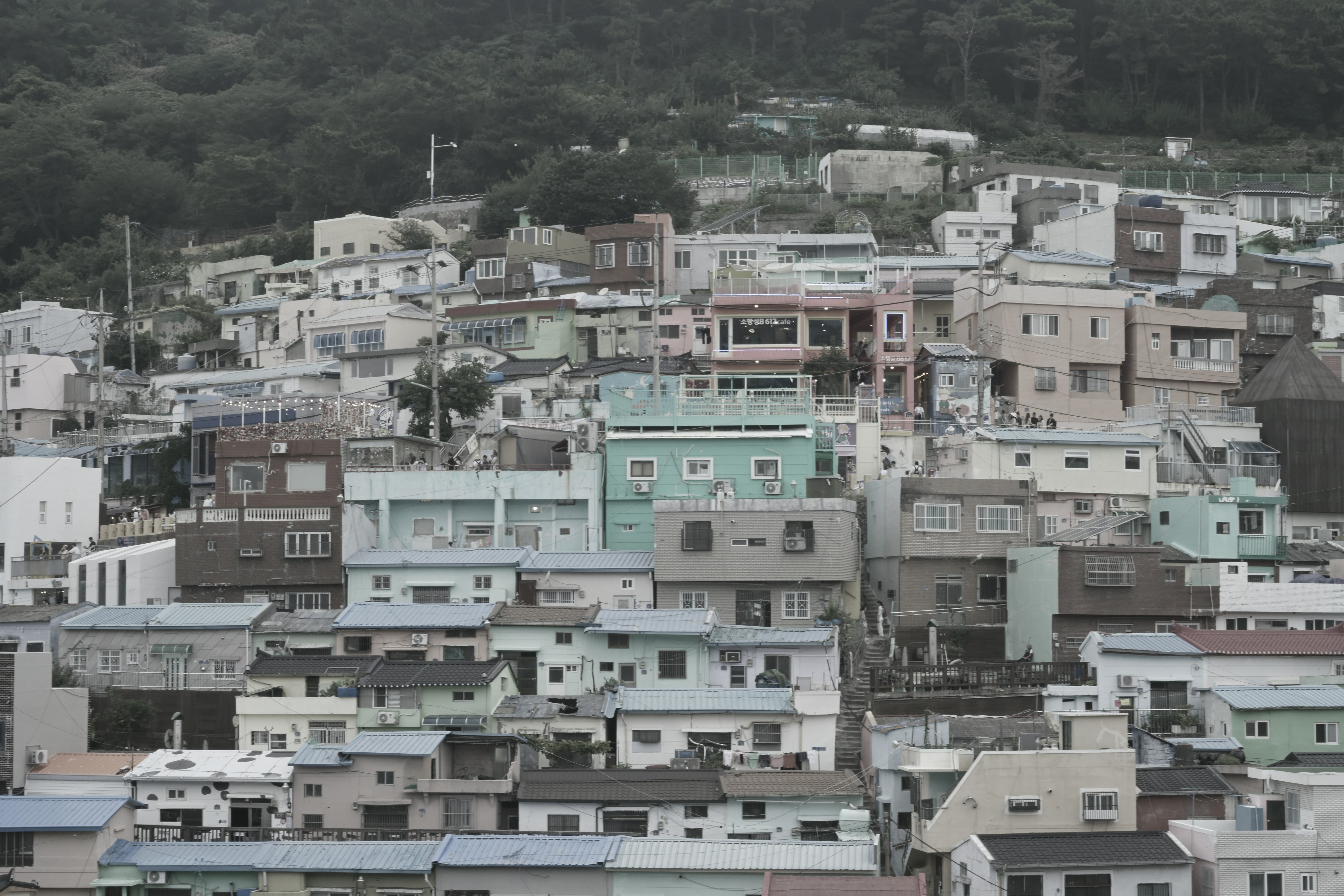 A dense hillside neighborhood of colorful houses in Busan, South Korea.